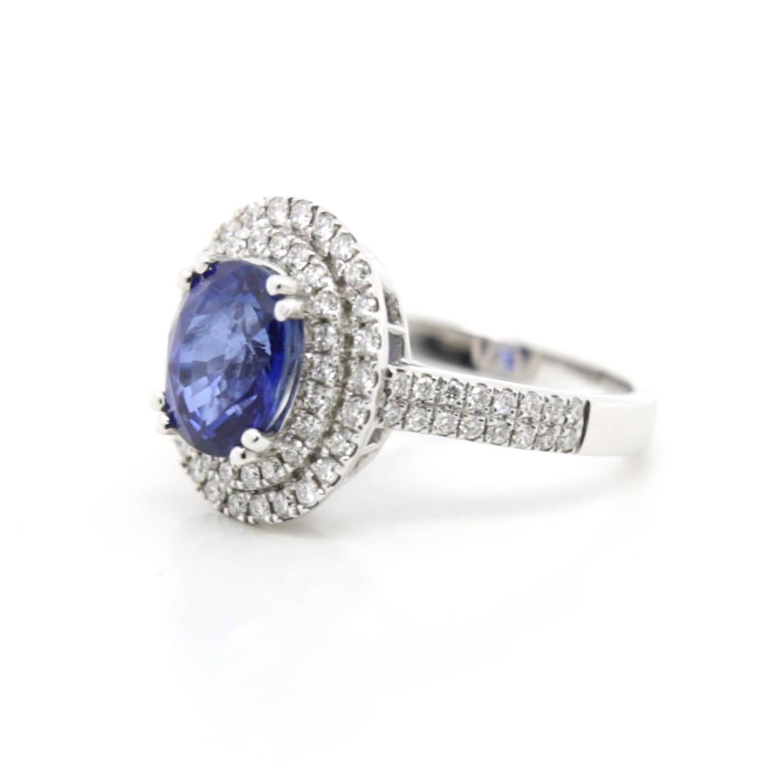 Timeless Majesty: The Blue Sapphire Double Halo Diamond Ring

This extraordinary ring embodies a blend of classic beauty and timeless elegance, centering around a magnificent 3.21-carat oval-shaped blue sapphire. The sapphire's captivating hue,