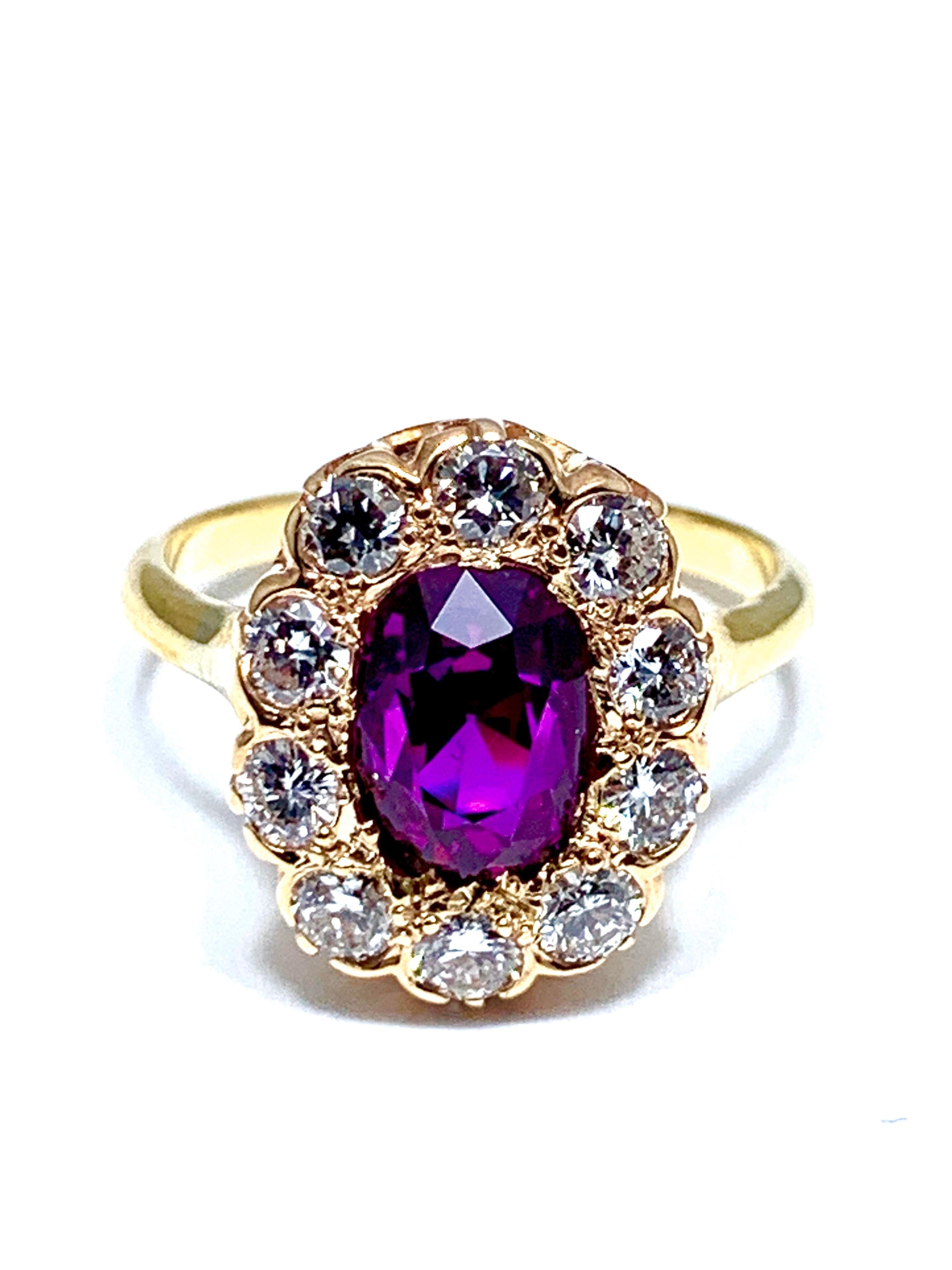An absolutely eye catching purplish pink Sapphire and Diamond yellow gold ring.  The vibrant Sapphire is cushion shaped and weighs 3.21 carats.  It is set with a single row of 10 round brilliant diamonds weighing 0.80 carats.  The Sapphire has a