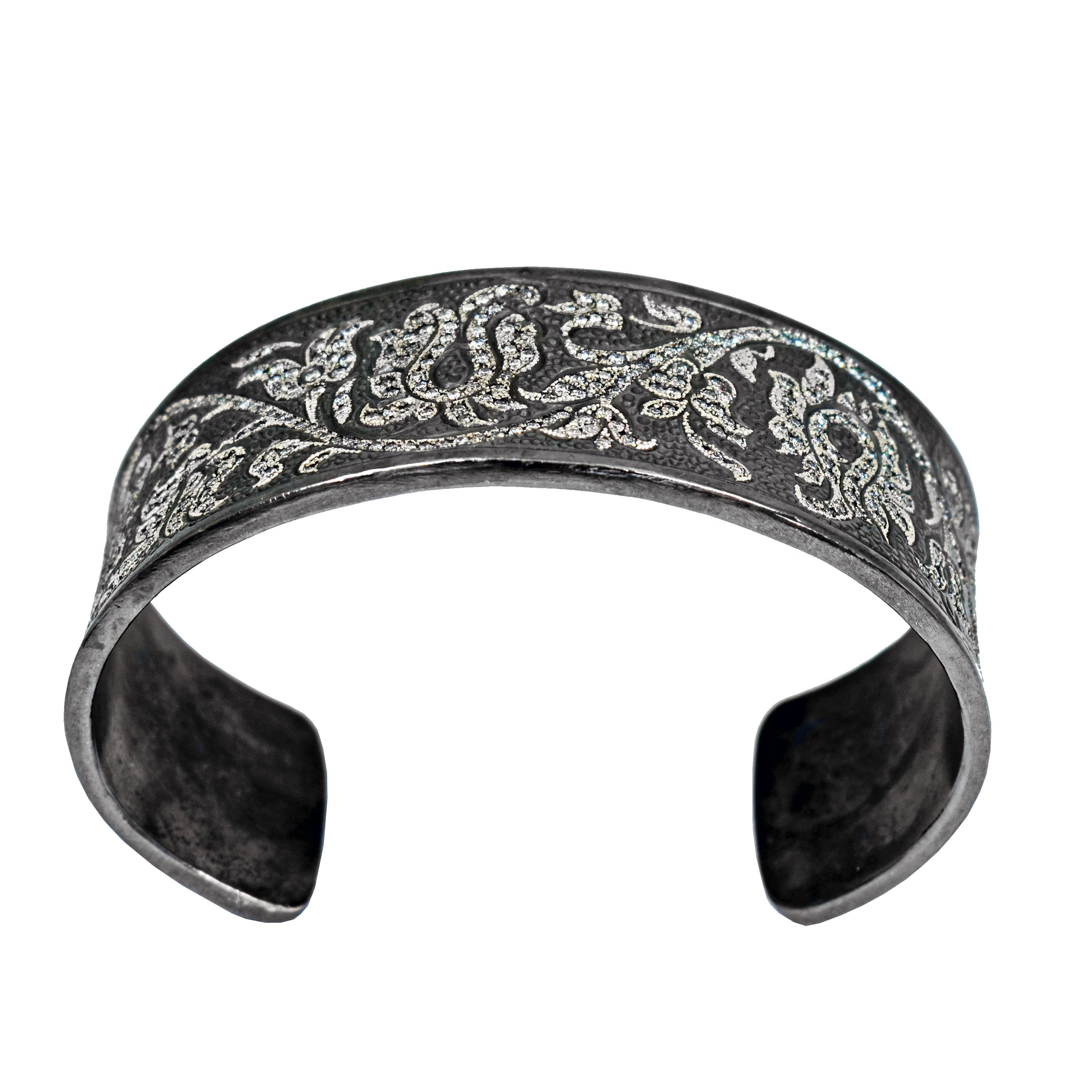 Diamond pavé and engraved / tooled design in an oxidized sterling silver cuff bracelet with over 3 carats of diamonds (3.21 carats, G-H, SI1). Cuff bracelet is 0.94 inch wide. Inside of bracelet is 2.44 inches across and cuff opening is 1.25 inches