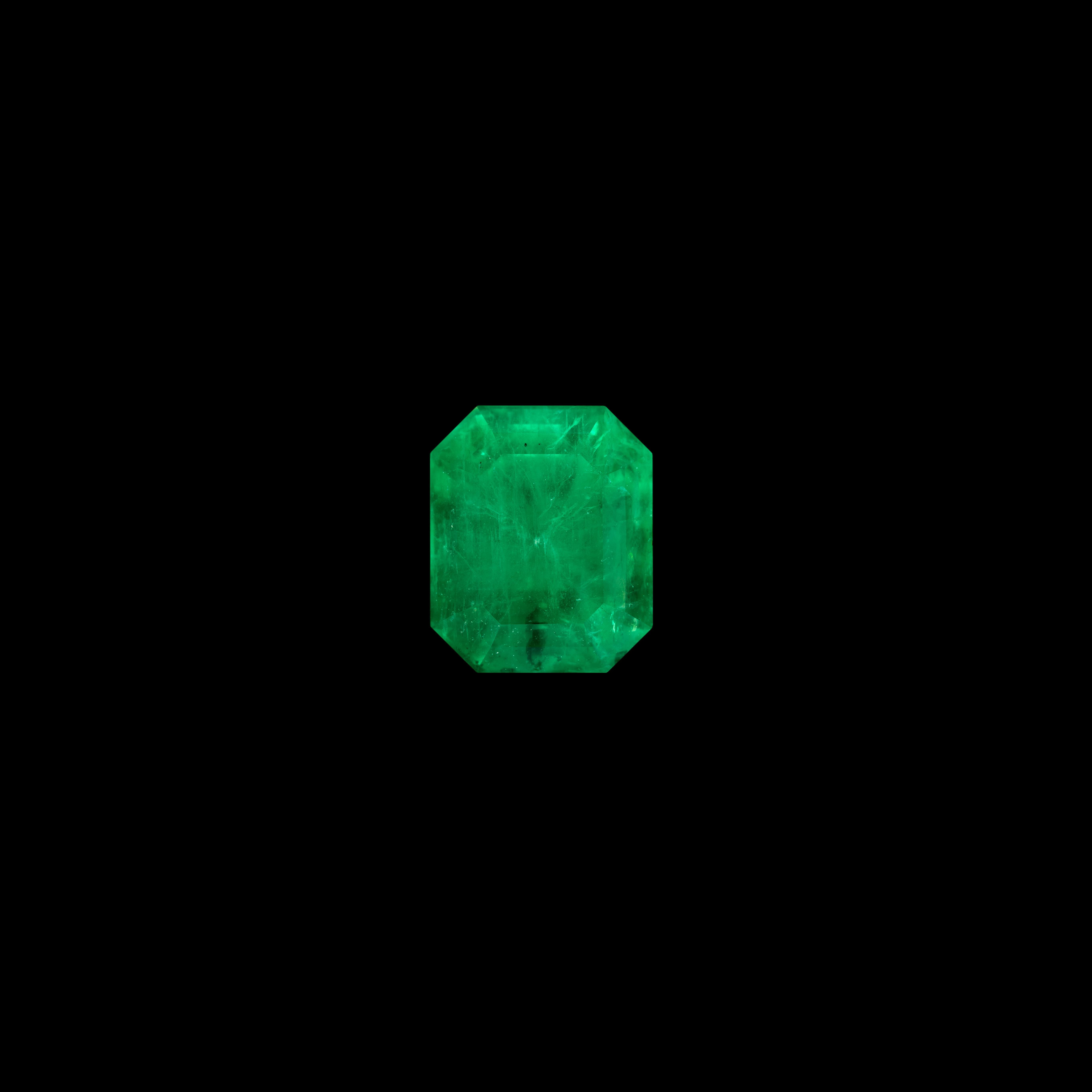 Esta esmeralda de 3,21 quilates está tallada en una clásica talla octogonal (escalonada) que acentúa su amplia tabla y sus facetas perfectamente alineadas. Su matiz verde medio profundo es extraordinariamente uniforme en toda la piedra, y el