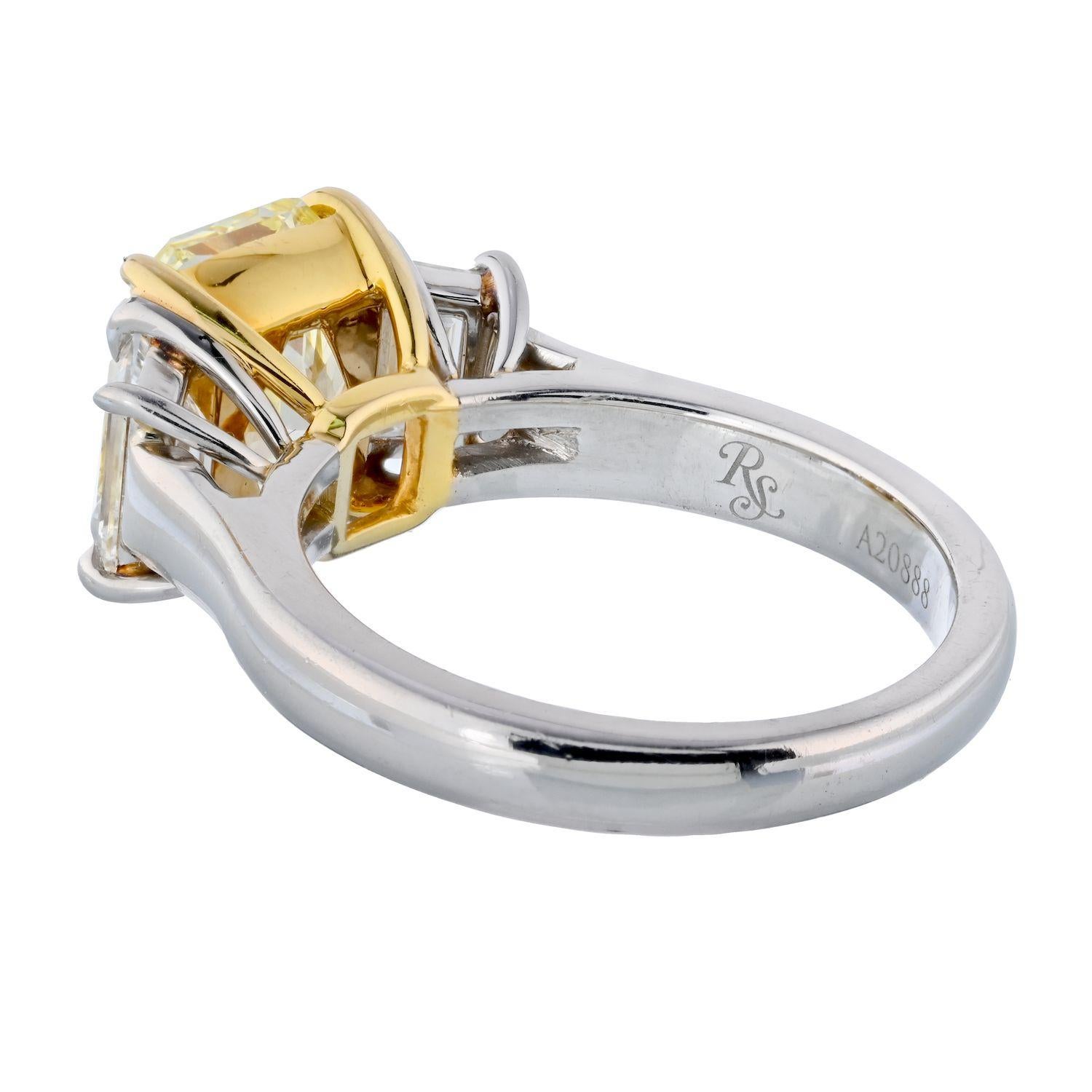Three-stone diamond engagement ring mounted with three beautiful diamonds. The center radiant cut diamond weighs 3.21cts and is flanked by two trapezoid-cut white diamonds. Mounted in platinum with yellow-gold center basket. 
Report: GIA