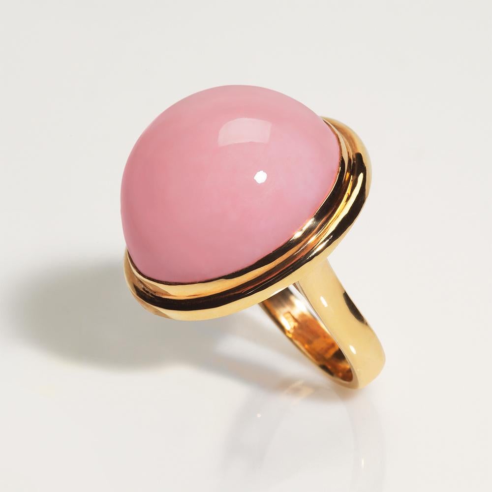 A fashion favorite one-of-a-kind Peruvian Pink Opal set in yellow gold statement ring. The gem quality pink cabochon is simply set with double gold bezel. This stunning pastel pink gemstone was mined in the Andes near San Patricio, Peru. This