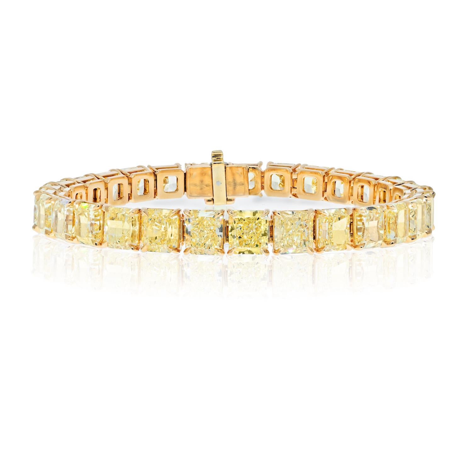Handmade diamond bracelet crafted in 18 k yellow gold, mounted with 29 diamonds of radiant cut. Each diamond is of fancy yellow color and is over 1 carat each. 
Diamonds vary from VVS2 to VS2 clarity and are all consistent in color.
Bracelet length: