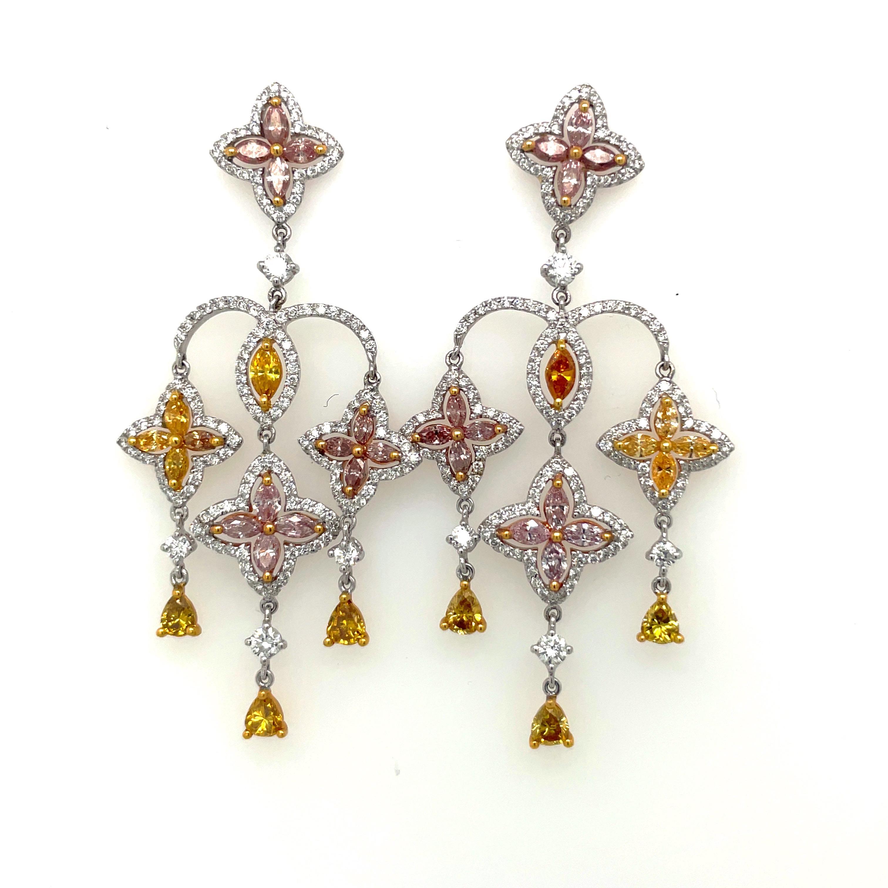 Chandelier earrings with three rows of fancy color diamonds in a arabesque motif, connected with a pavé of round brilliant white diamonds. Set in 18-karat gold. Approximately 2.25″ long.

Fancy color diamond weight: 3.21 total carats.
White diamond