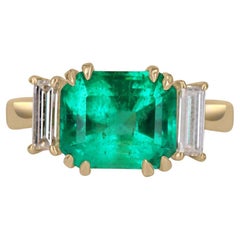 3.21tcw 18K Three Stone Emerald-Emerald Cut & Diamond Baguette Ring