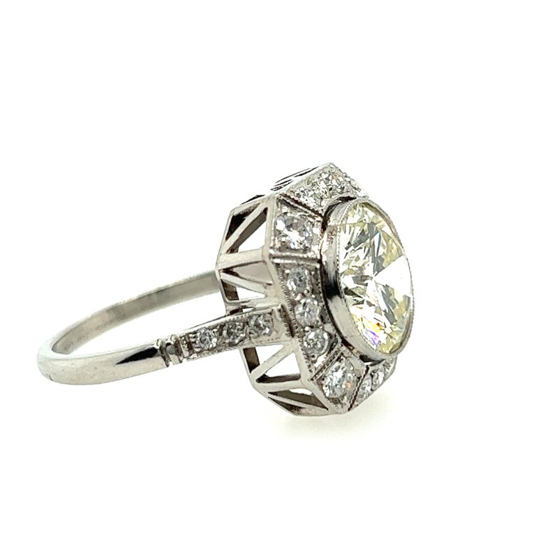 This vintage Art Deco style ring from the 1950s boasts a dazzling 3.22 carat round brilliant diamond that's been expertly cut to maximize its sparkle and brilliance. The M color grade of the diamond gives it a warm, inviting tone that will