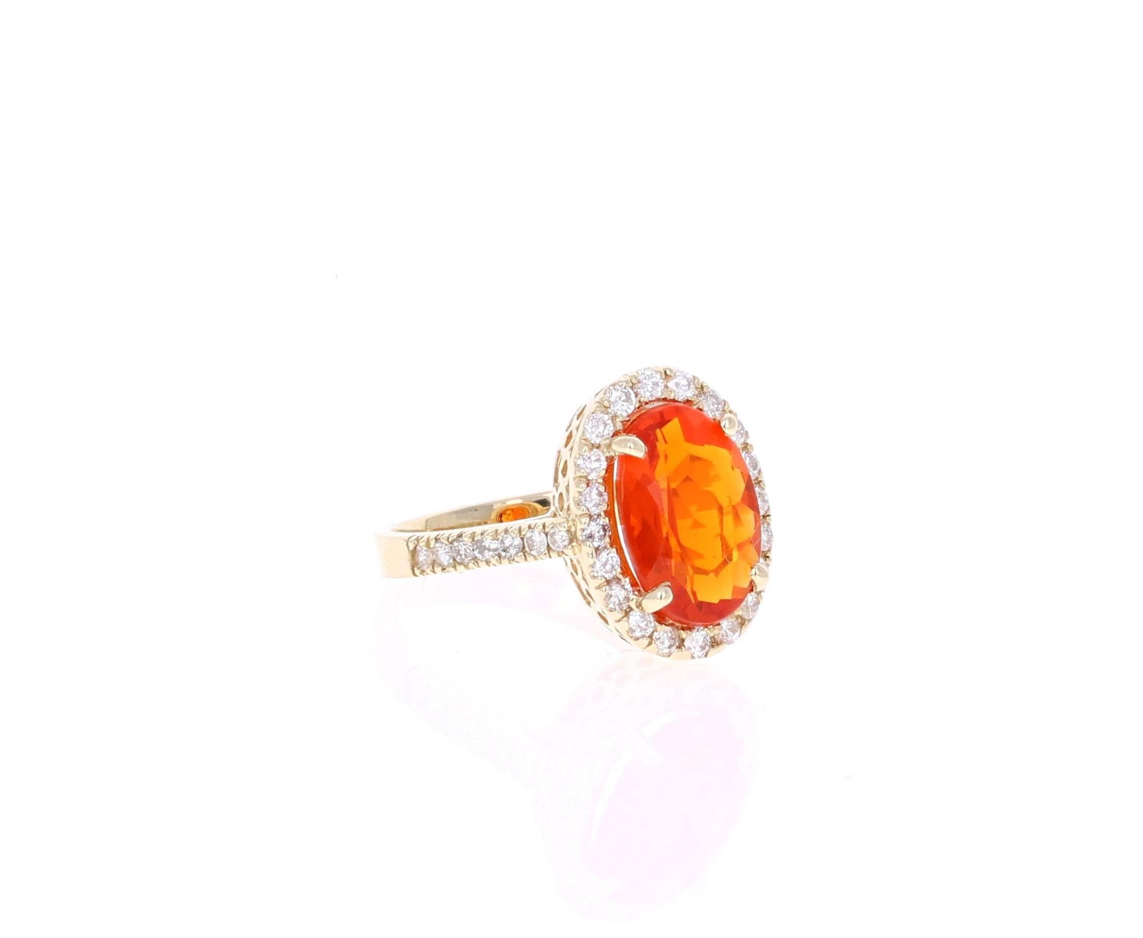 Beautiful Fire Opal and Diamond Ring. This ring has an Oval Cut 2.52 carat Fire Opal in the center of the ring and is surrounded by a halo of 34 Round Cut Diamonds that weigh a total of 0.70 carat.  The total carat weight of the ring is 3.22 carats.
