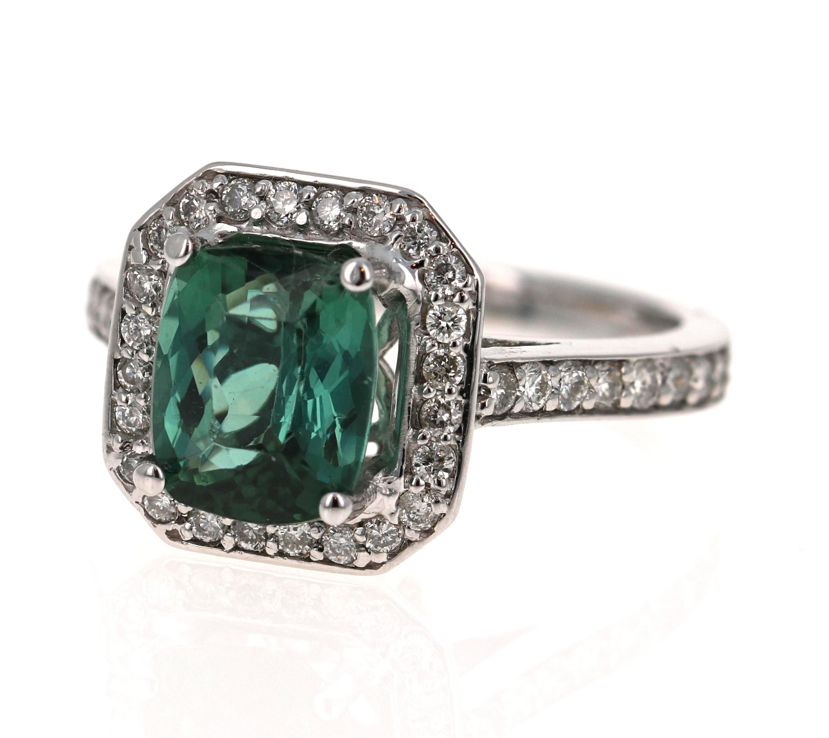 This gorgeous ring has a beautiful Cushion Cut Green Tourmaline weighing 2.55 Carats and is surrounded by 77 Round Cut Diamonds weighing 0.67 Carats (Clariy: SI, Color: F).   The total Carat weight is 3.22 Carats.  

It is set in 14K White Gold and
