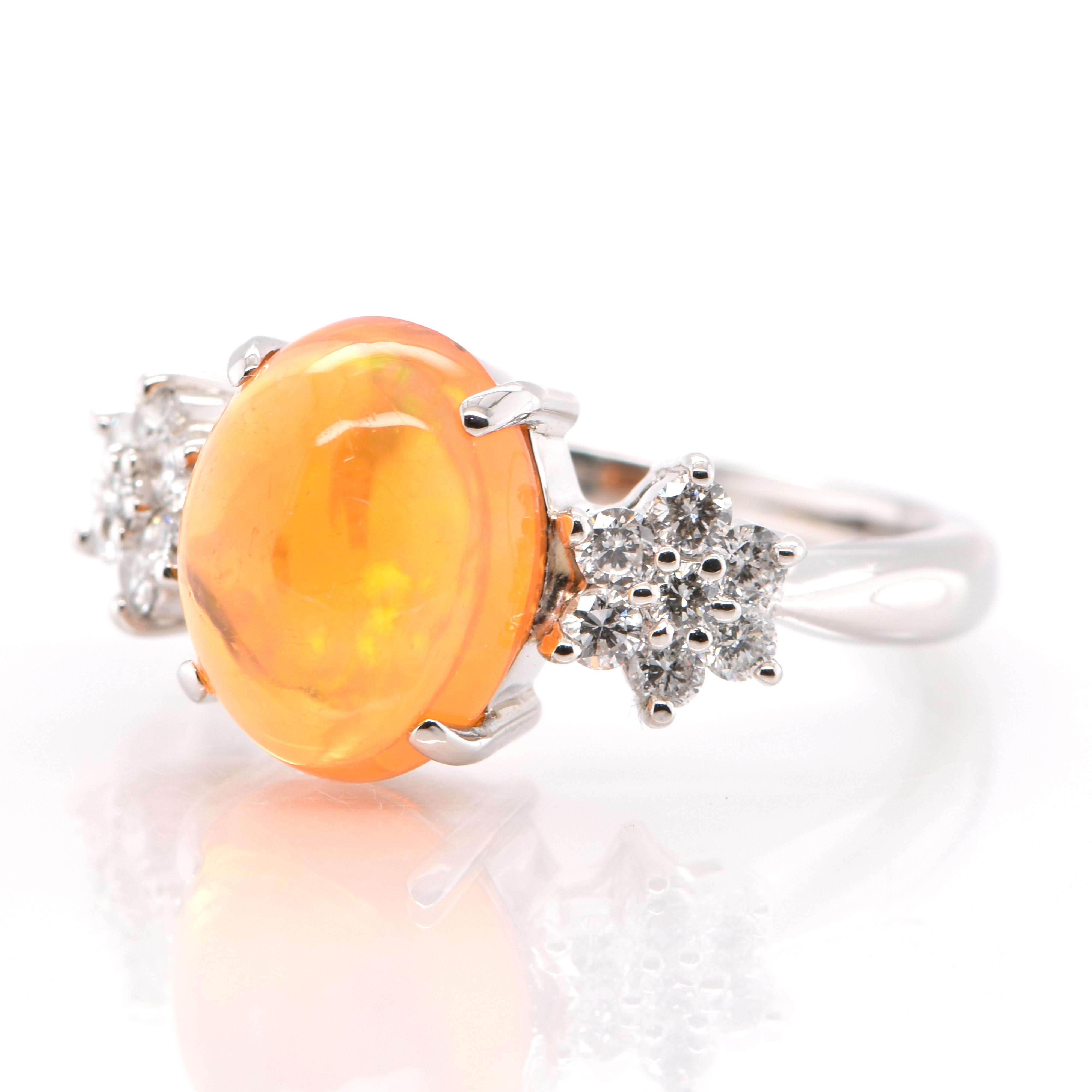 A beautiful Engagement Ring featuring a 3.22 Carat, Natural Mexican Fire Opal with very good play of color and 0.47 Carats of Diamond Accents set in Platinum. Opals are known for exhibiting flashes of rainbow colors known as 