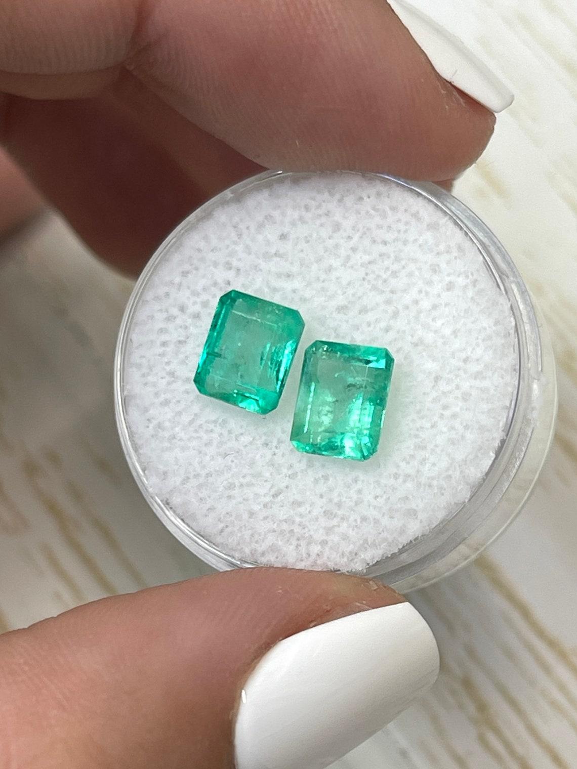 Stone: Emerald
Total Weight: 3.22-tcw
Shape: Emerald Cut
Clarity: Transparent
Luster: Very Good
Color: Medium Bluish Green
Measurements: 7.32mm x 6.24mm x 4.77mm // 7.59mm x 6.65mm x 5.15mm
Geographic Origin: Colombia
Treatment: Natural, Oiling

No