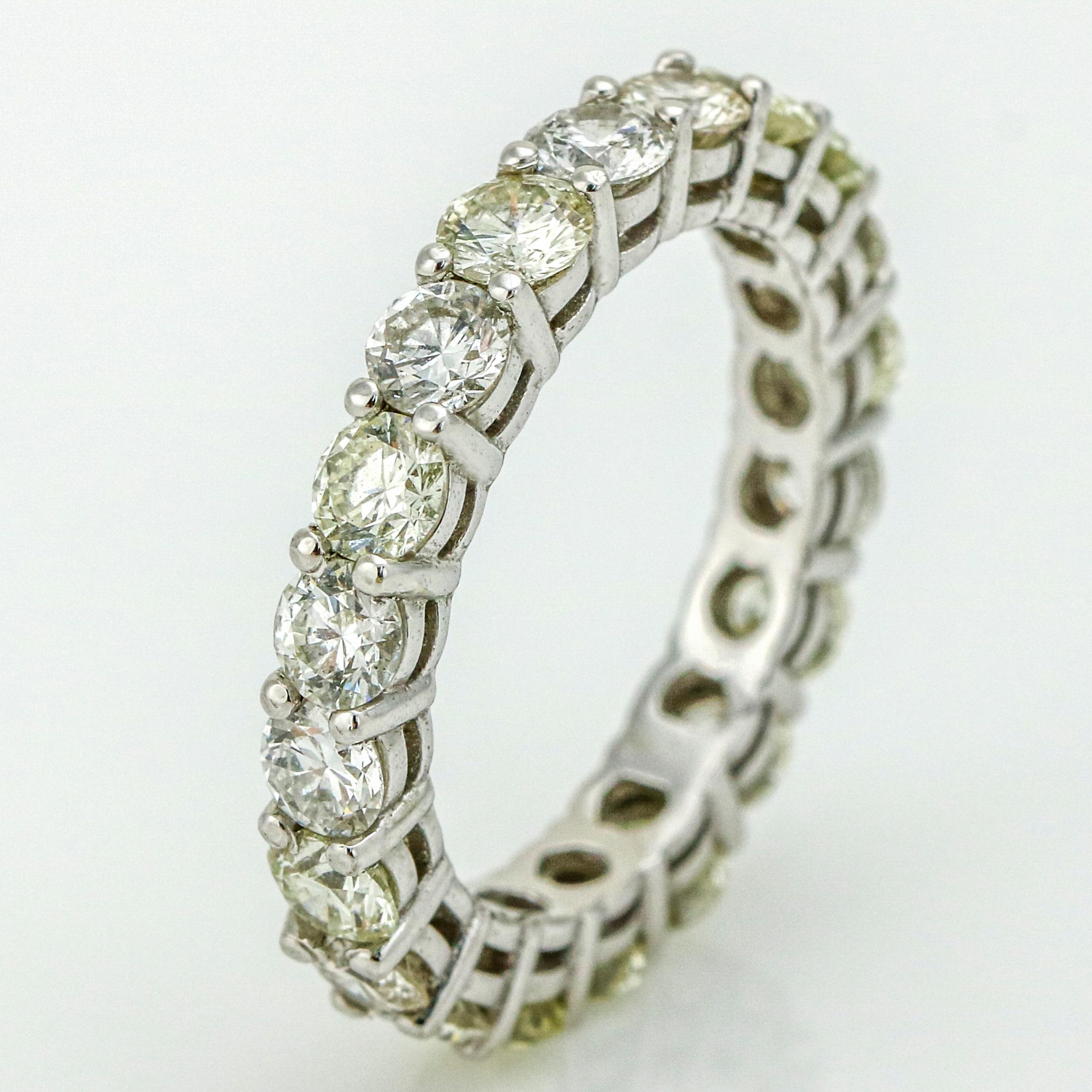 Diamond eternity band in 14-karat white gold. Two prong setting with 19 round brilliant-cut light colored and clear natural diamonds. Size, 6.75. Total carat weight, 3.23 carats. Diamond Clarity, VS-SI