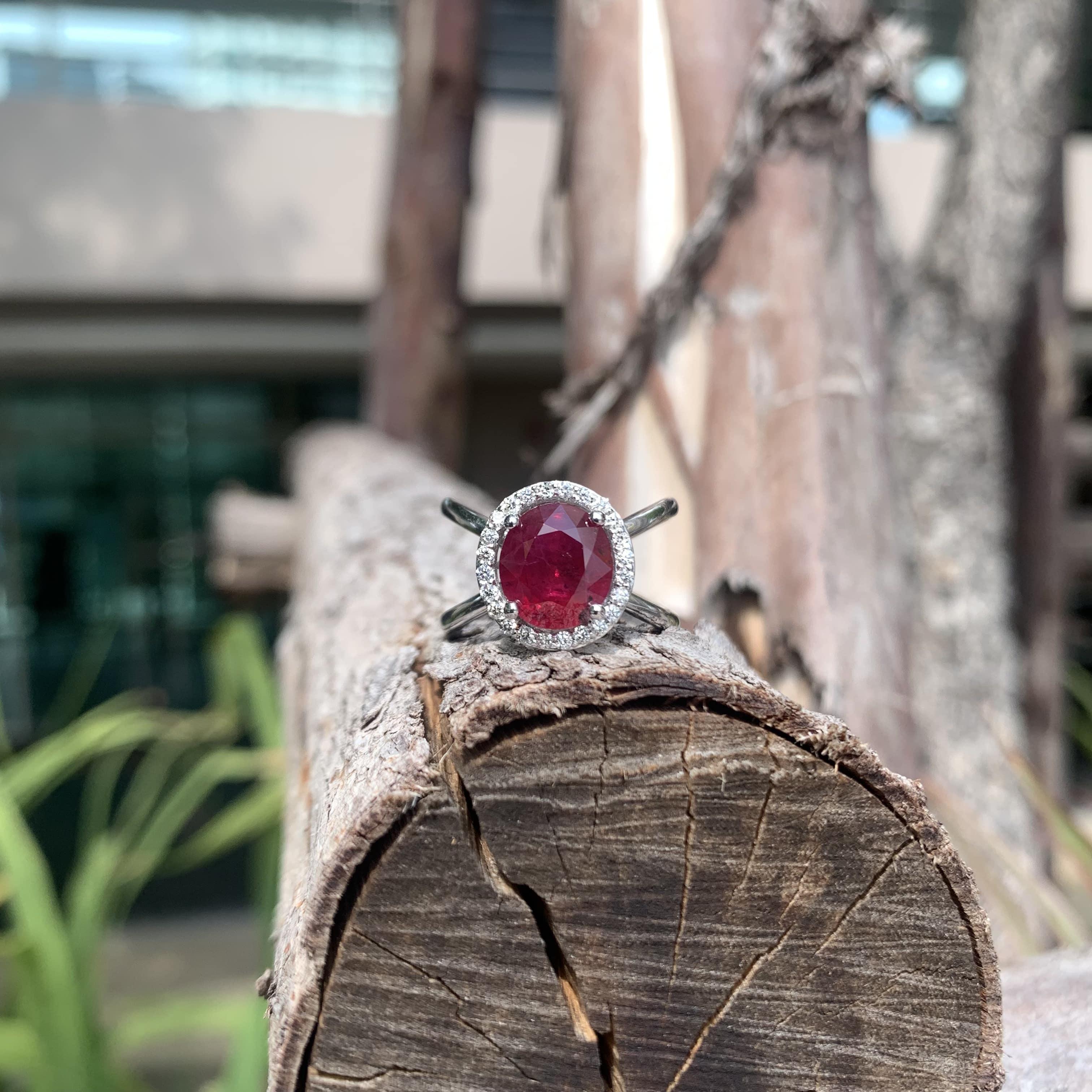 At the heart of this exquisite ring lies a mesmerizing 3.23 Carat Ruby, radiating a rich and deep red hue that symbolizes passion and elegance. Originating from Mozambique, the Ruby boasts a resplendent pigeon blood hue, radiating an irresistible