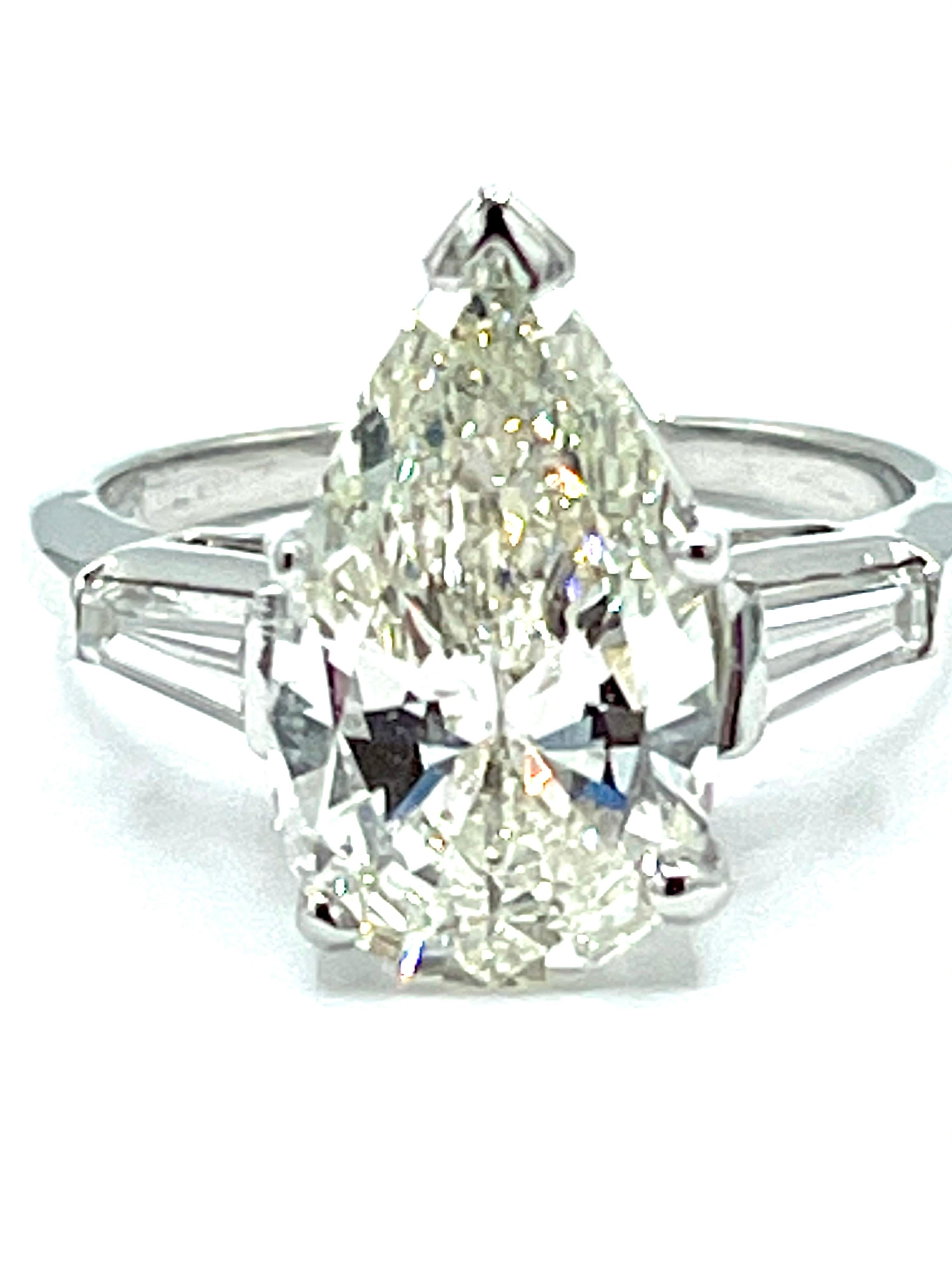 A gorgeous 3.24 carats pear shape brilliant Diamond engagement ring.  The Diamond is set in a five prong basket, with two tapered baguettes tapering down toward the shank of the ring.  The pear shape is graded by GIA as L color, I1 clarity, and has