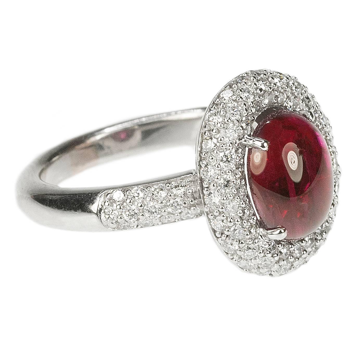 White Gold Ring with AGL certified 3.24 carat cabochon ruby and approximately 1.00 carats of modern round brilliant diamonds.