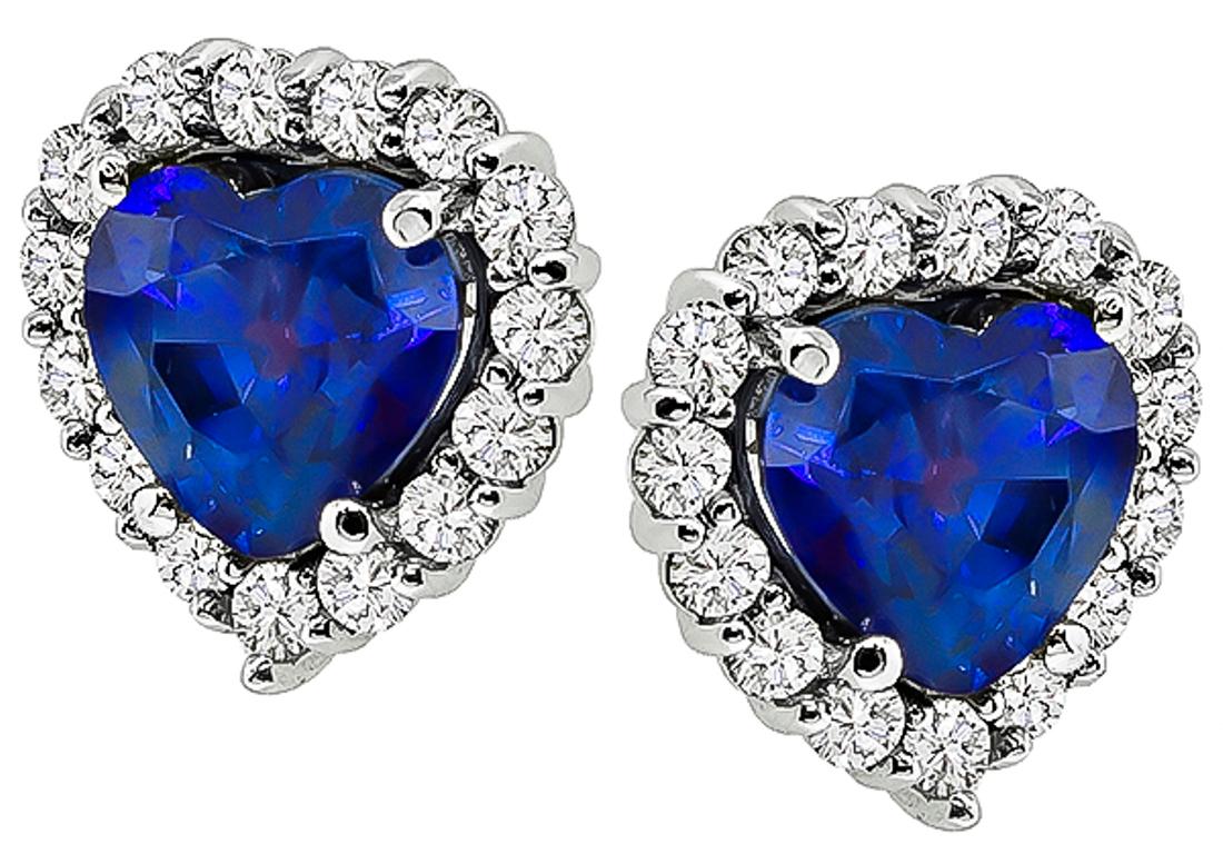 Made of 18k white gold, these earrings feature stunning heart shape sapphires that weigh 3.24ct. The sapphires are accentuated by sparkling round cut diamonds that weigh approximately 0.58ct. graded G-H color with VS clarity. The earrings measure