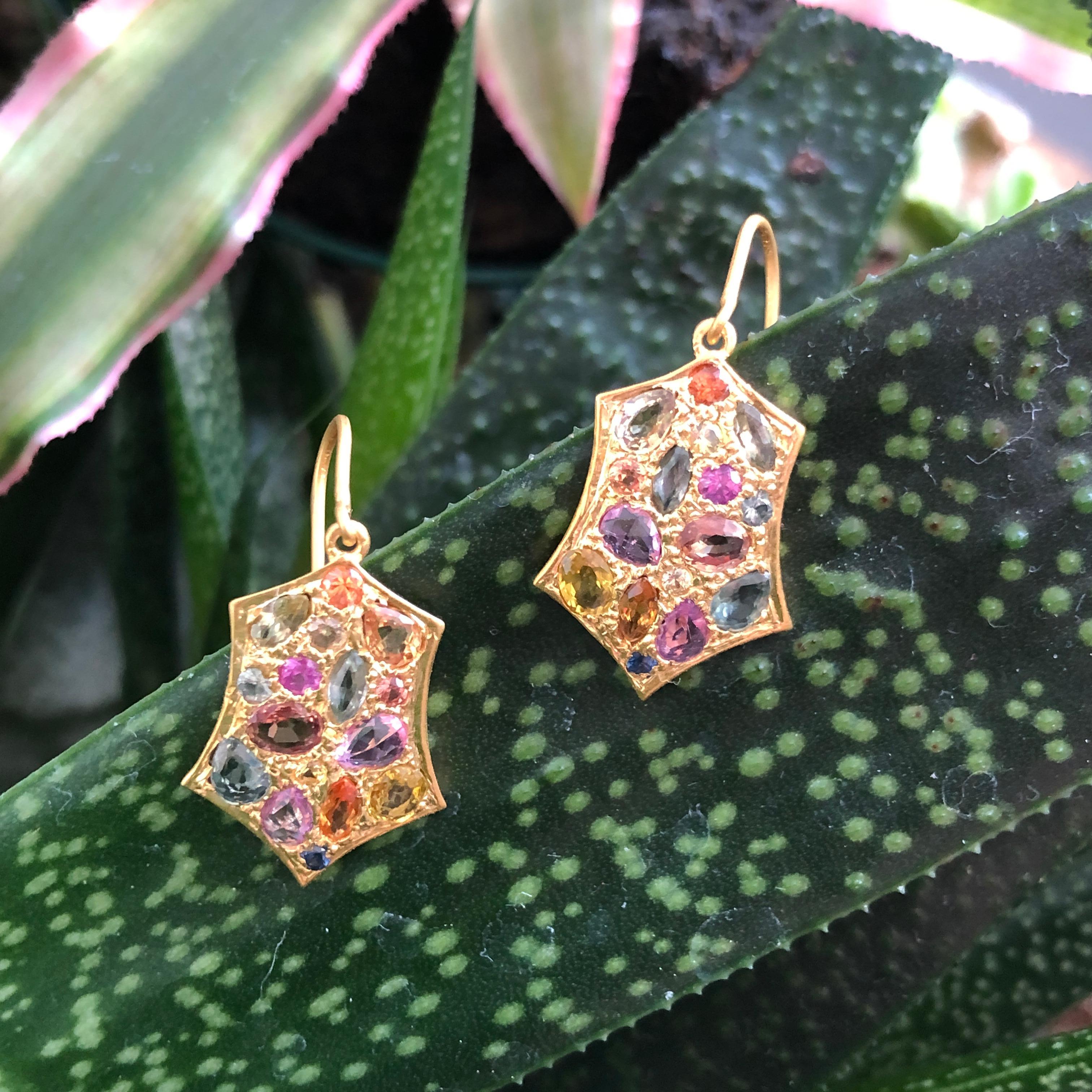 Designed by award winning Jewelry Designer, Lauren Harper, these 18kt Solid Gold hand made earrings feature faceted 3.24 cts of Multicolored Sapphires set in an intricate grain setting.  Sapphires range in color from pink, orange, yellow, green and