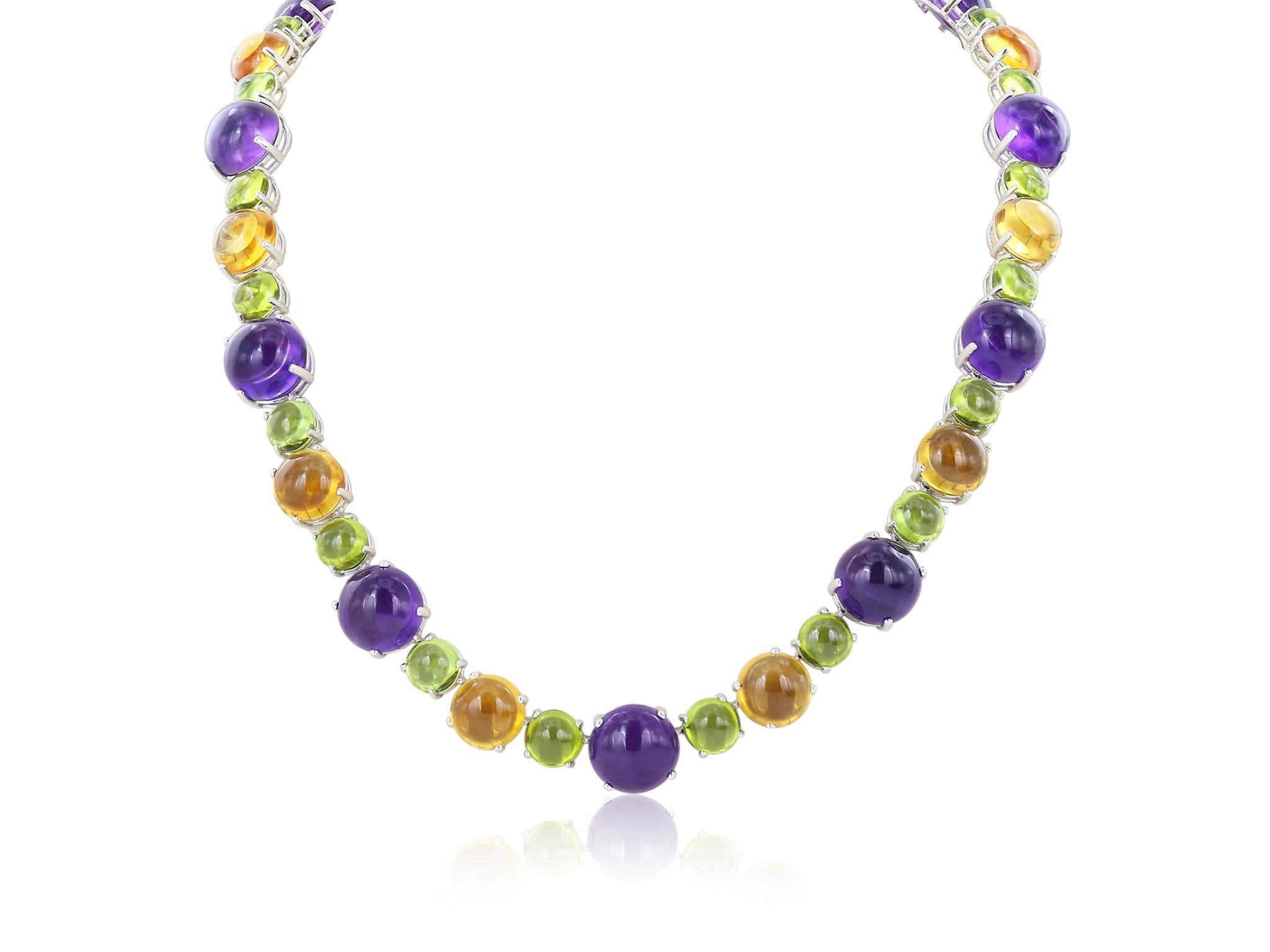 Stunning 18 karat white gold multi color necklace consisting of 20 round amethyst cabochon stones having a total weight of 117.91 carats, 20 round cabochon citrine stones having a total weight of 107.36 carats, and 40 round cabochon peridot stones