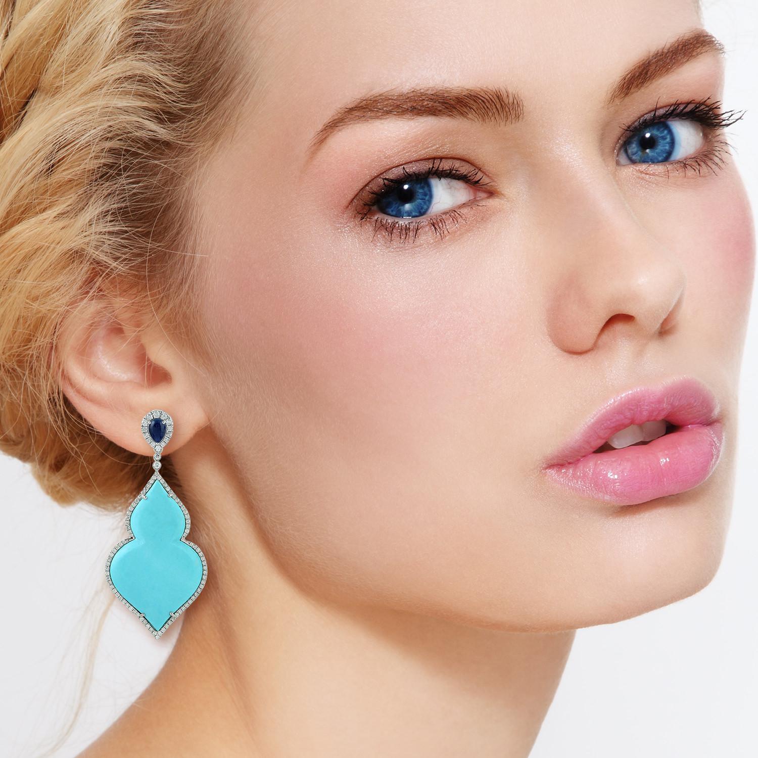 Handcrafted from 18-karat gold, these beautiful earrings are set with 32.45 carats Turquoise, 1.9 carats blue sapphire and 1.85 carats of glimmering diamonds.

FOLLOW  MEGHNA JEWELS storefront to view the latest collection & exclusive pieces. 