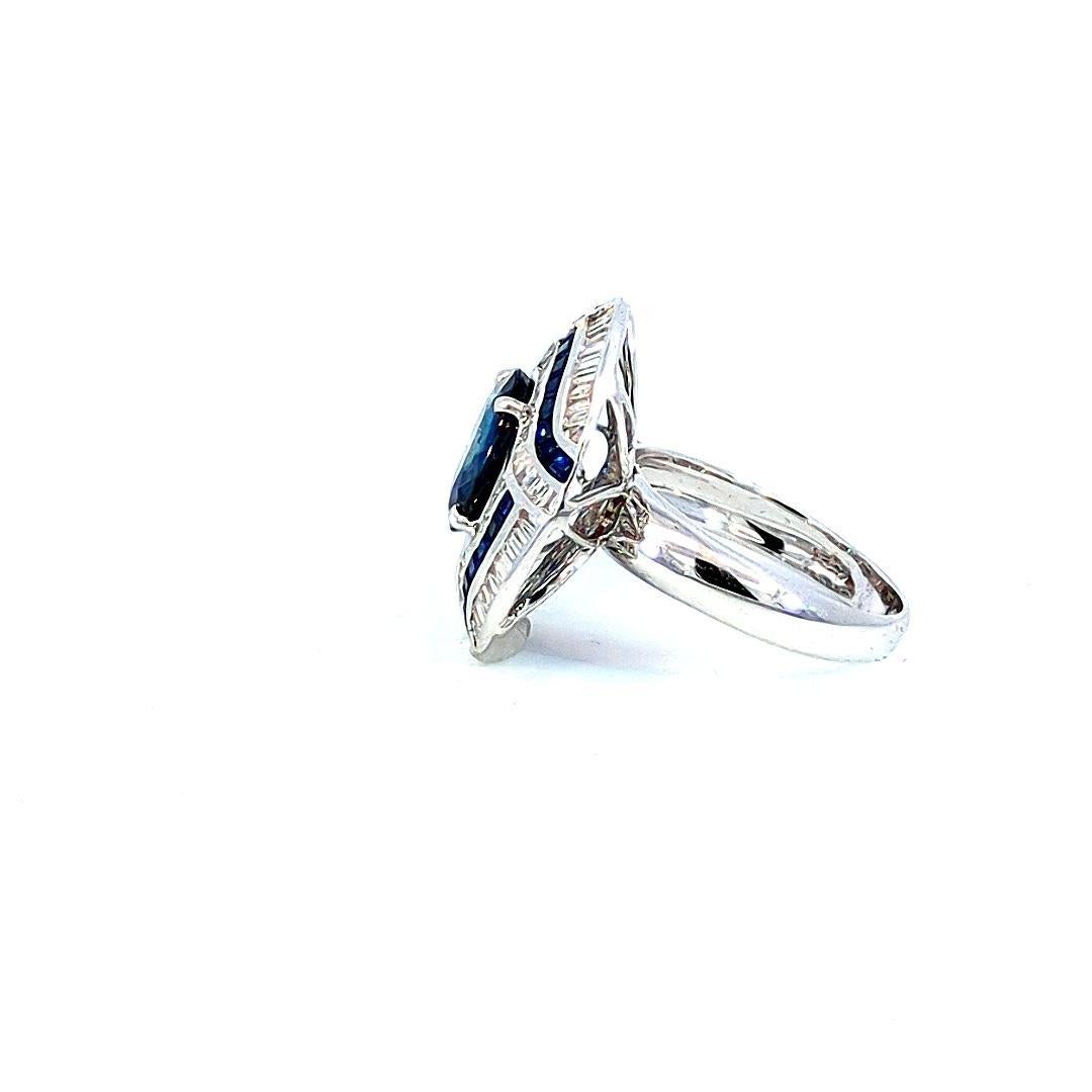 Step into the elegance of the Art Deco era with our 3.25 Carat Blue Sapphire Deco-Style Ruby Ring. At the heart of this exquisite piece lies a stunning 3.25 carat oval Blue Sapphire, celebrated for its deep, enchanting blue color and fine clarity.