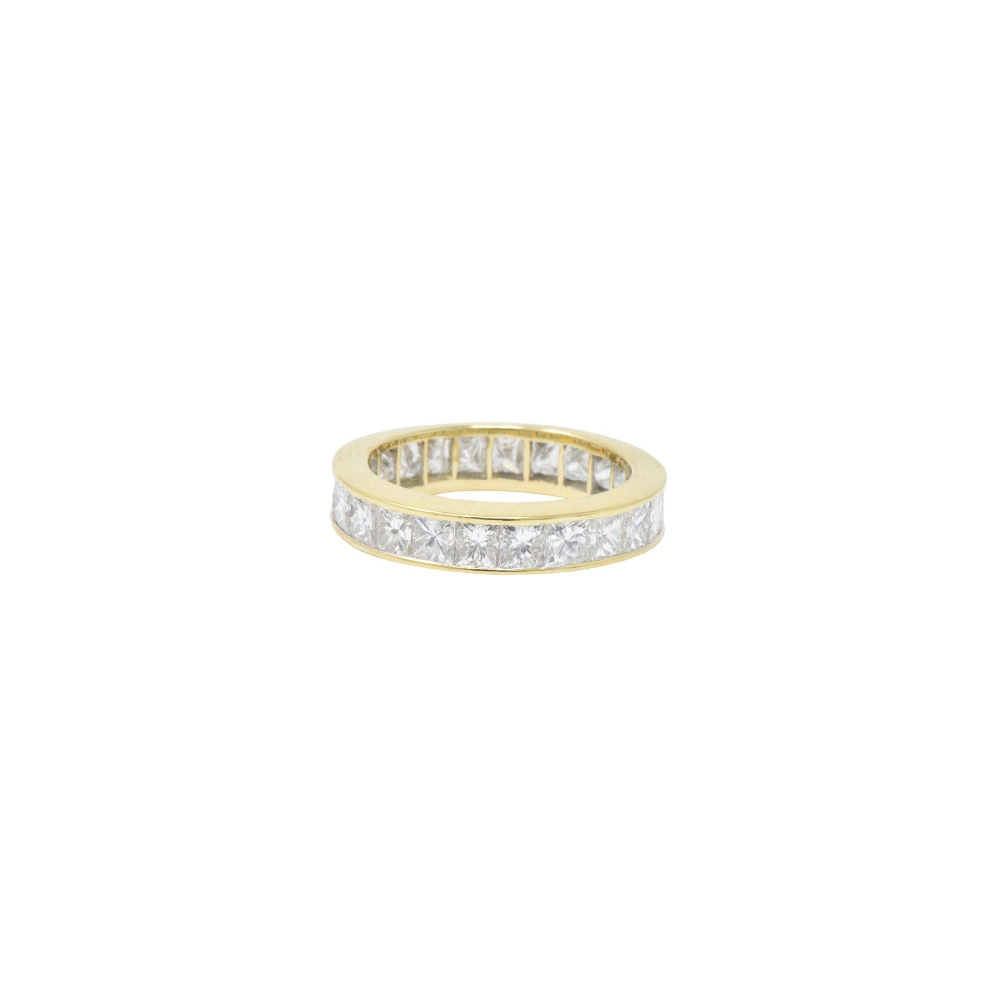 Eternity style band ring channel set fully around by twenty-three very well-matched princess cut diamonds

Total diamond weight is approximately 3.25 carats, G/H color with VVS to VS clarity

Completed by highly polished channel walls

Tested as 18