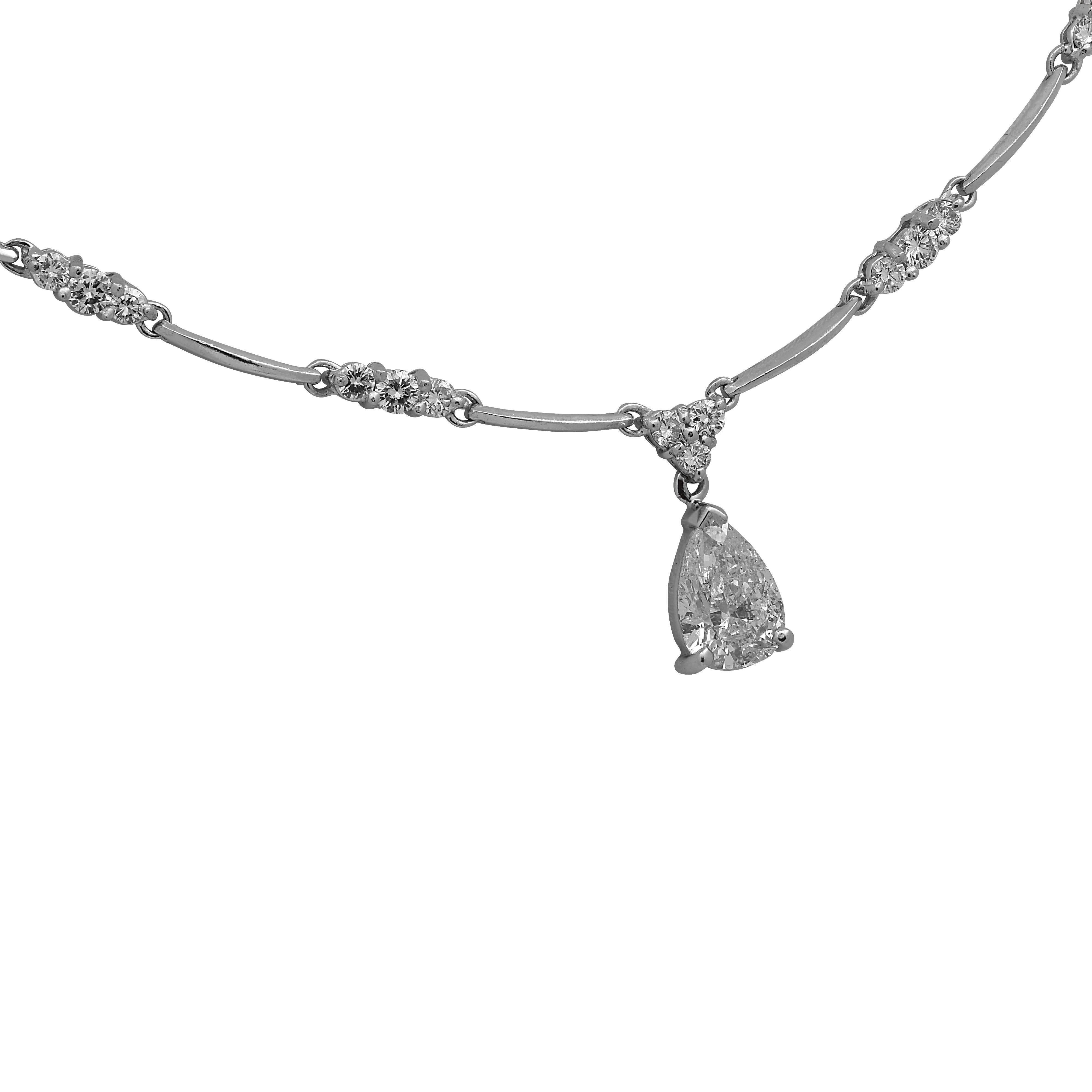 Stunning necklace crafted in 18 karat white gold featuring a pear shape diamond weighing approximately 1.25 carats, G color, SI3 clarity accented by 35 round brilliant cut diamonds weighing approximately 2 carats total, G color VS-SI clarity. The