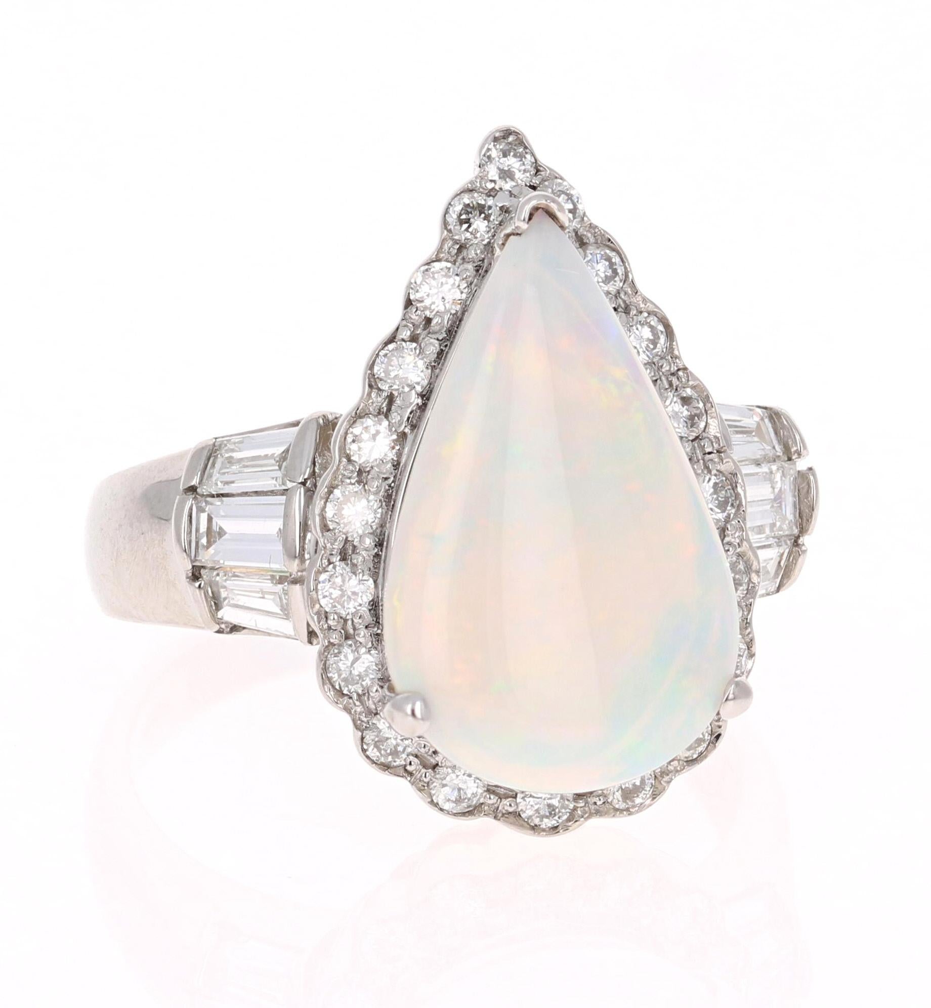 Stunning 3.25 Carat Opal and Diamond Ring that can easily transform into an Engagement Ring! 
There is a gorgeous 2.42 Carat Pear Cut Opal that is set in the center of the ring. It is surrounded by 20 Round Cut Diamonds that weigh 0.33 carat and 6