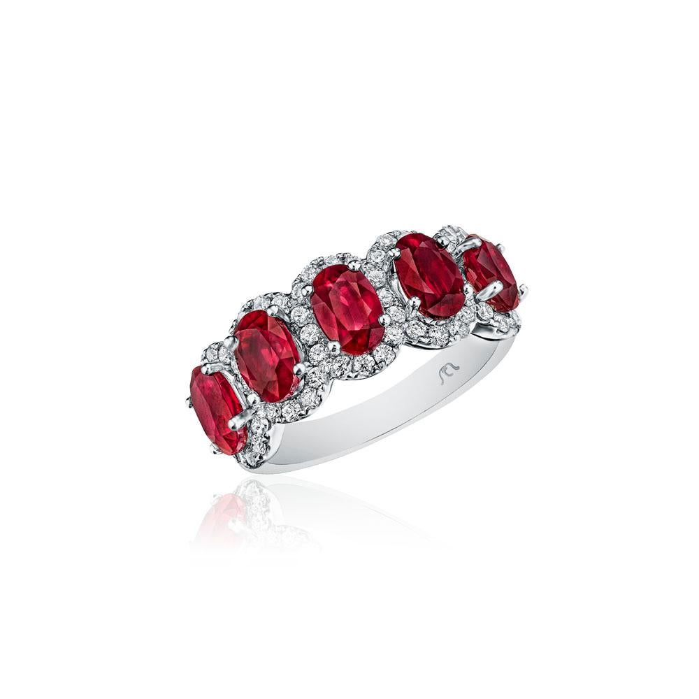 • Crafted in 14KT gold, this band is made with 5 oval cut red rubies which are framed by a delicate halo comprised of round brilliant cut diamonds. The band has a combining total weight of approximately 3.25 carats. 

Worn beautifully on its own, or