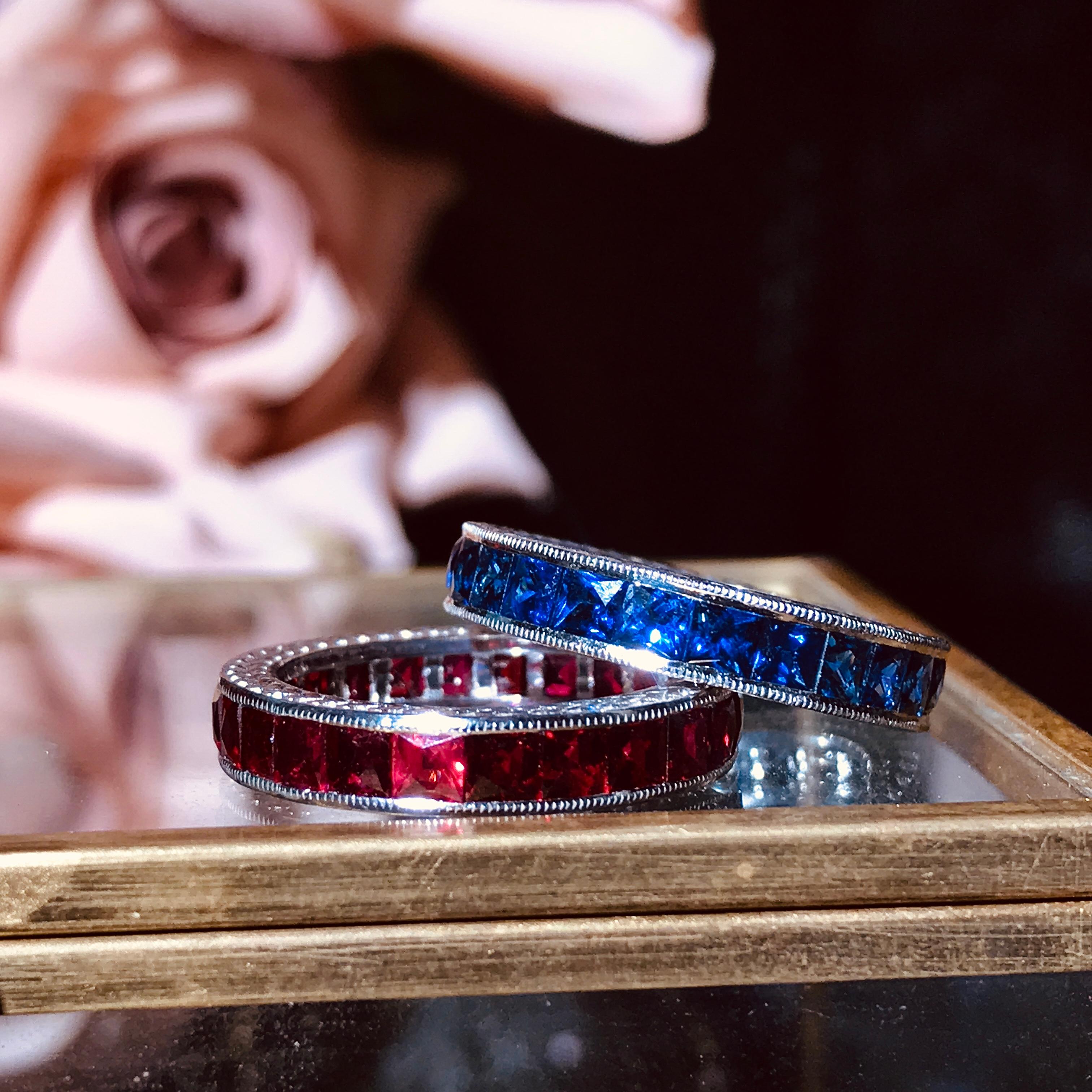 A beautiful blue sapphire eternity band inspired by the Art Deco era. This lovely ring features a row of luscious French cut blue sapphires, which rest in a continuous channel setting. Each delicate sapphire displays a vivid blue color. This could