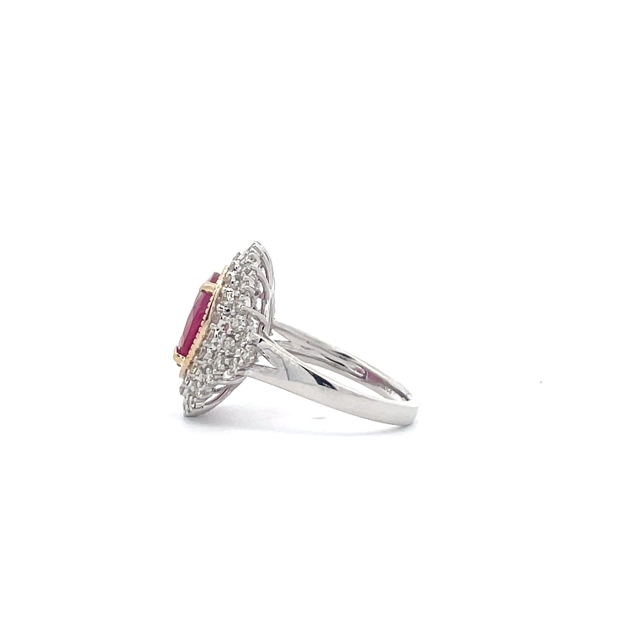 Let the fire of this Oval Ruby & Diamond Halo Ring warm your heart. Crafted by professional artisans with a passion for detail, it features a 3.25 CT oval ruby surrounded by diamond halo prongs and an intricate sophisticated design. This ring is