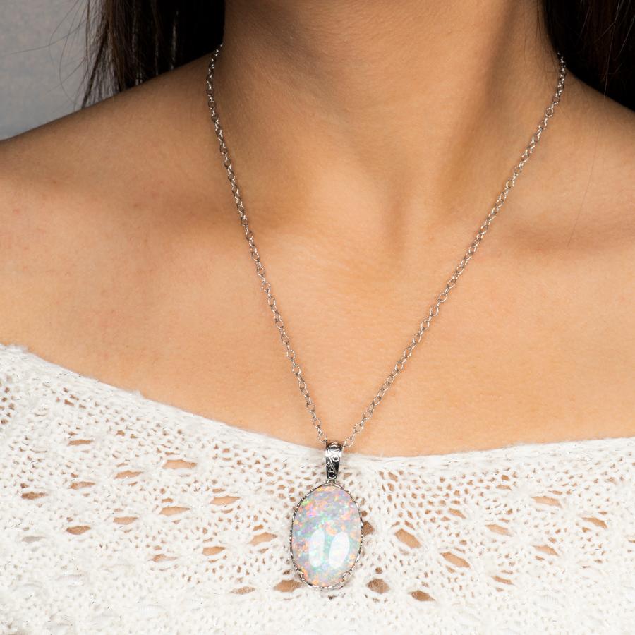 32.opale ovale de 58 carats certifiée par le GIA, montée sur un pendentif en platine. Ce magnifique spécimen présente des jeux de couleurs vives dans toute la pierre, ce qui est très rare pour une opale fine de cette taille. 

Mesures de l'opale :