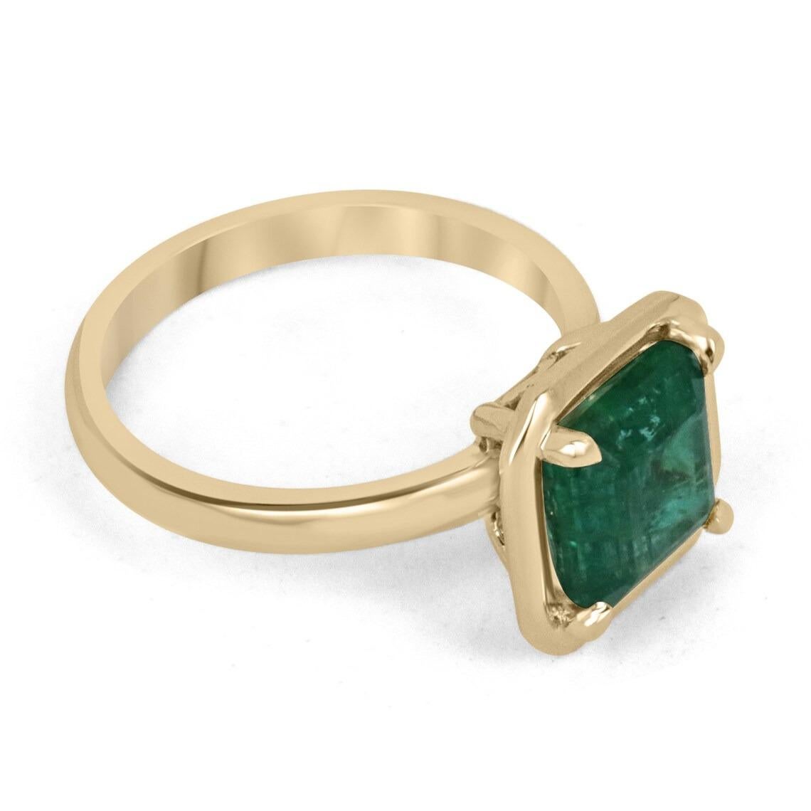 Displayed is a classic emerald solitaire Asscher-cut engagement ring/right-hand ring in 14K yellow gold. This gorgeous solitaire ring carries a full 3.25-carat emerald in a four-prong setting. Fully faceted, this gemstone showcases excellent shine.