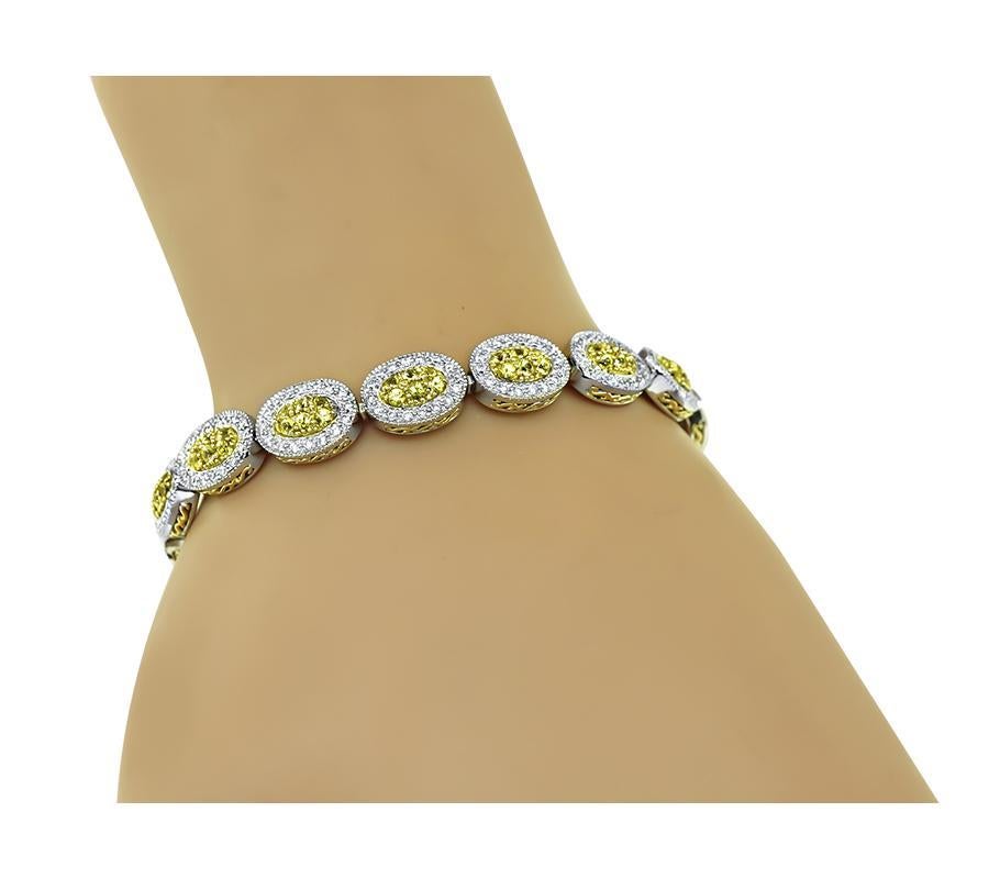 This is a stunning 18k yellow and white gold bracelet. The bracelet features lovely round cut yellow sapphires that weigh approximately 3.25ct. The sapphires are accentuated by sparkling round cut diamonds that weigh approximately 1.28ct. The color