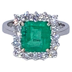 3.26 Carat Colombian Emerald and 1.02 Carat 18 Kt White Gold Halo Diamond Ring 