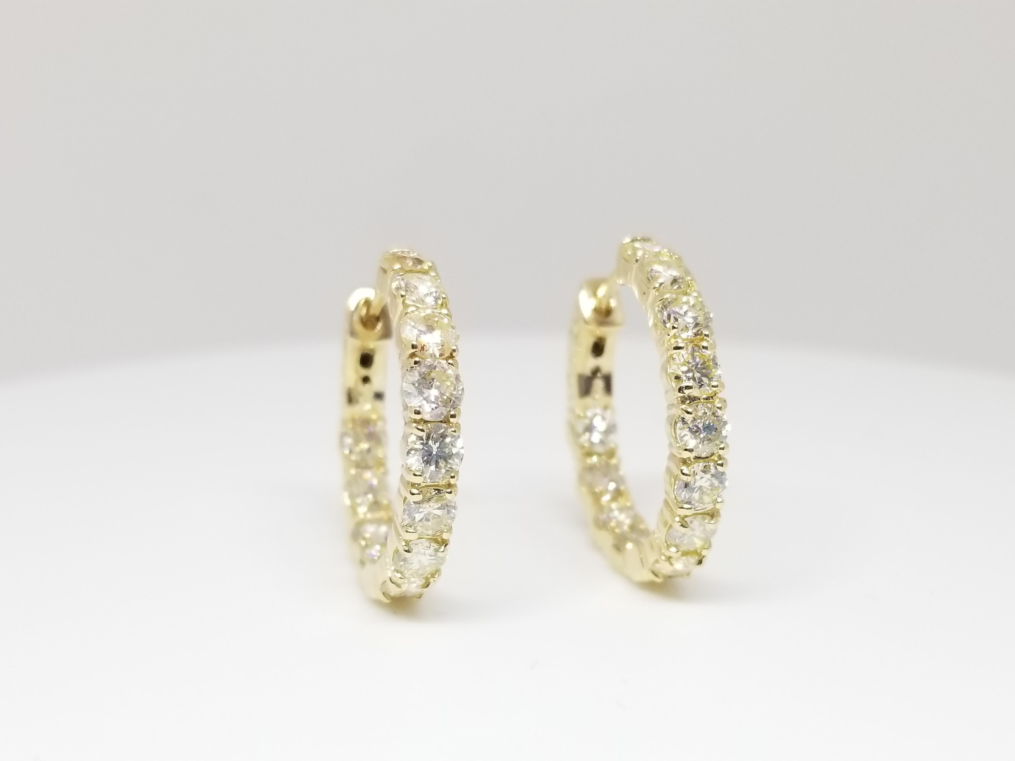 Beautiful pair of huggie diamond inside out hoop earrings available in 14k yellow gold. Secures with snap closure for wear.  Measures 3/4 inch or 2mm in diameter. Beautiful stock for the holiday!