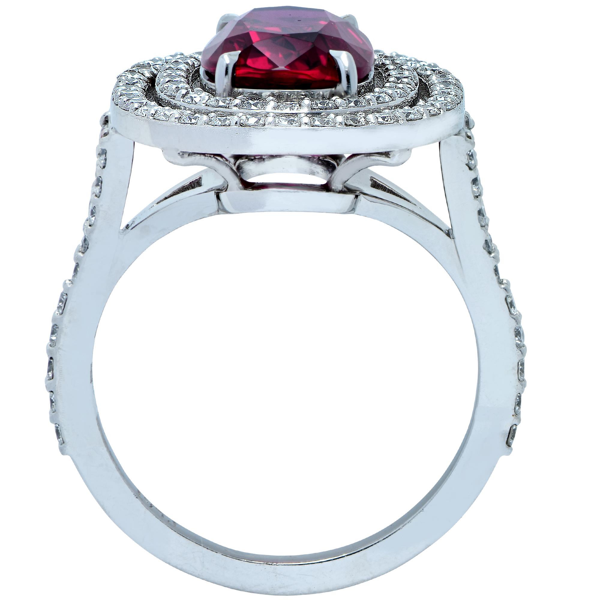 Stunning double halo ring crafted in platinum, showcasing a gorgeous AGL Certified oval ruby weighing  3.26 carats, adorned with 90 round brilliant cut diamonds weighing approximately .90 carats total weight, G color VS clarity. The spectacular ruby