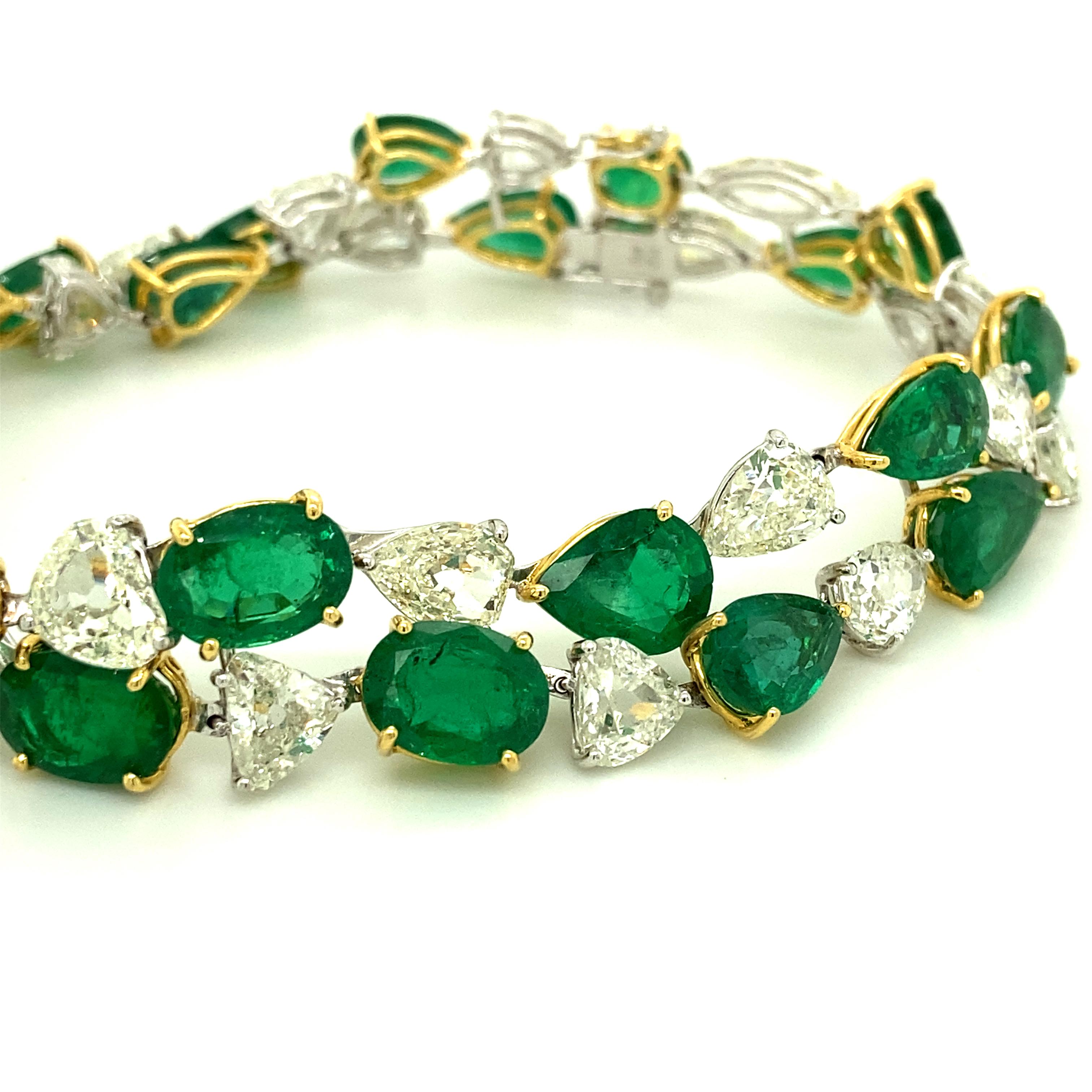 32.62 Carat Emerald and White Old Cut Diamond Gold Bracelet:

A spectacular piece of jewellery, it features twenty-two stunning oval and pear shaped emeralds weighing 32.62 carat, along with twenty-two gorgeous old-mine cut white diamonds weighing