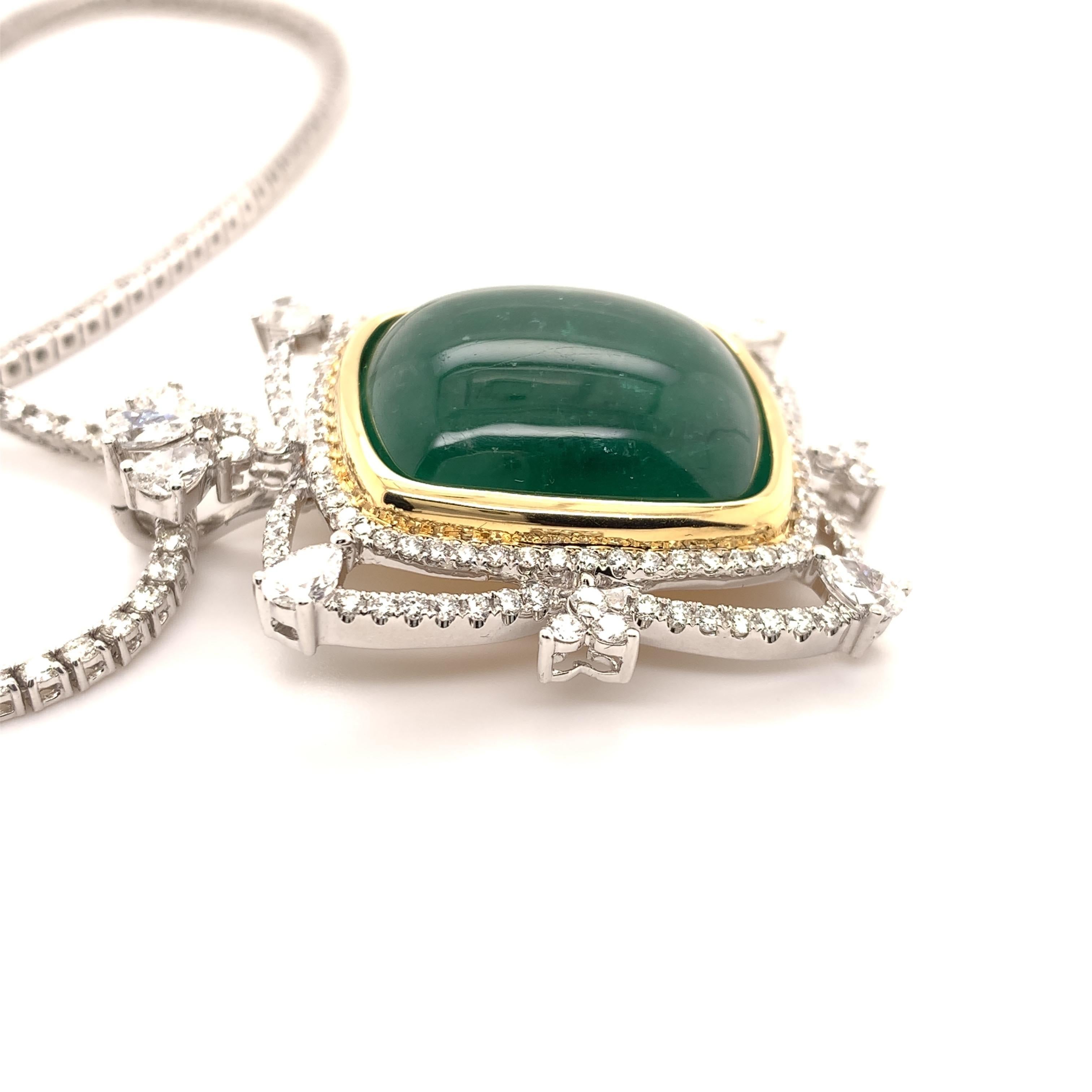 Elegant emerald diamond necklace. Rich green, Colombian, 32.63 carats natural cabochon emerald encased in a yellow gold bezel setting, accented with pear shape and round brilliant cut diamonds. Handcrafted masterpiece design set in 18 karats