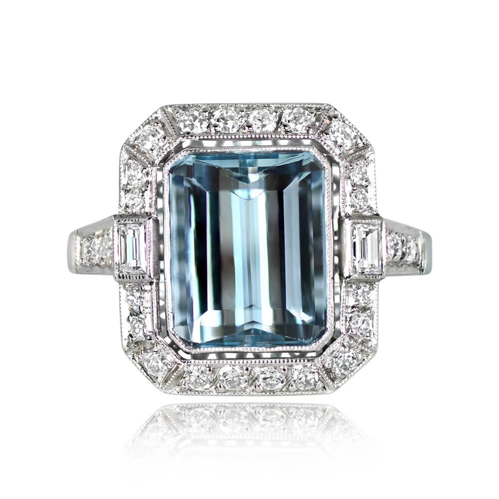 A splendid gemstone ring highlighting a 3.26-carat emerald-cut aquamarine, bezel-set and adorned with an old European cut diamond halo. Baguette-cut diamonds complement the center stone, while rows of old European-cut diamonds grace each shoulder.