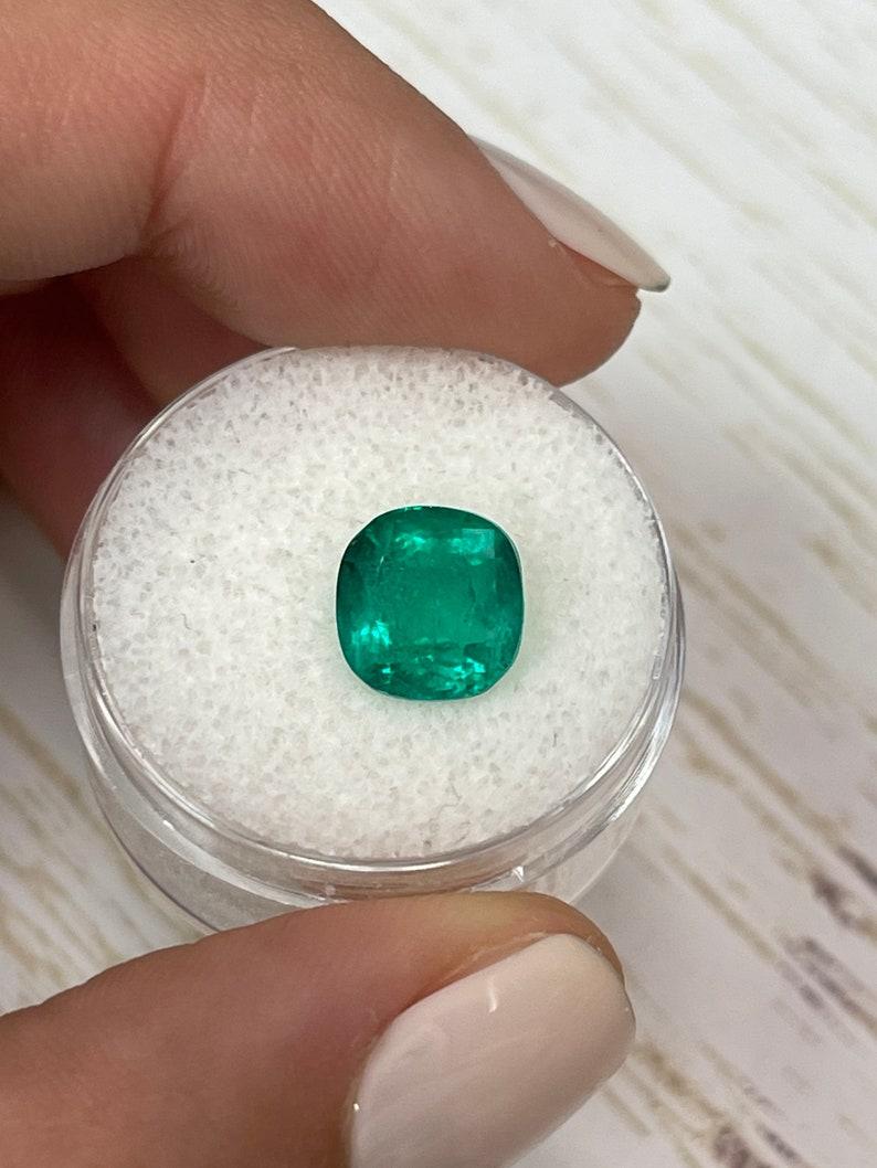 Stone: Emerald
Weight: 3.27-carats
Shape: Cushion Cut
Clarity: Transparent
Luster: Very Good
Color: Vivid Green
Measurements: 9.06mm x 8.77mm x 6.04mm
Geographic Origin: Colombia
Treatment: Natural, Minor Oil

Comments: Due to their growth