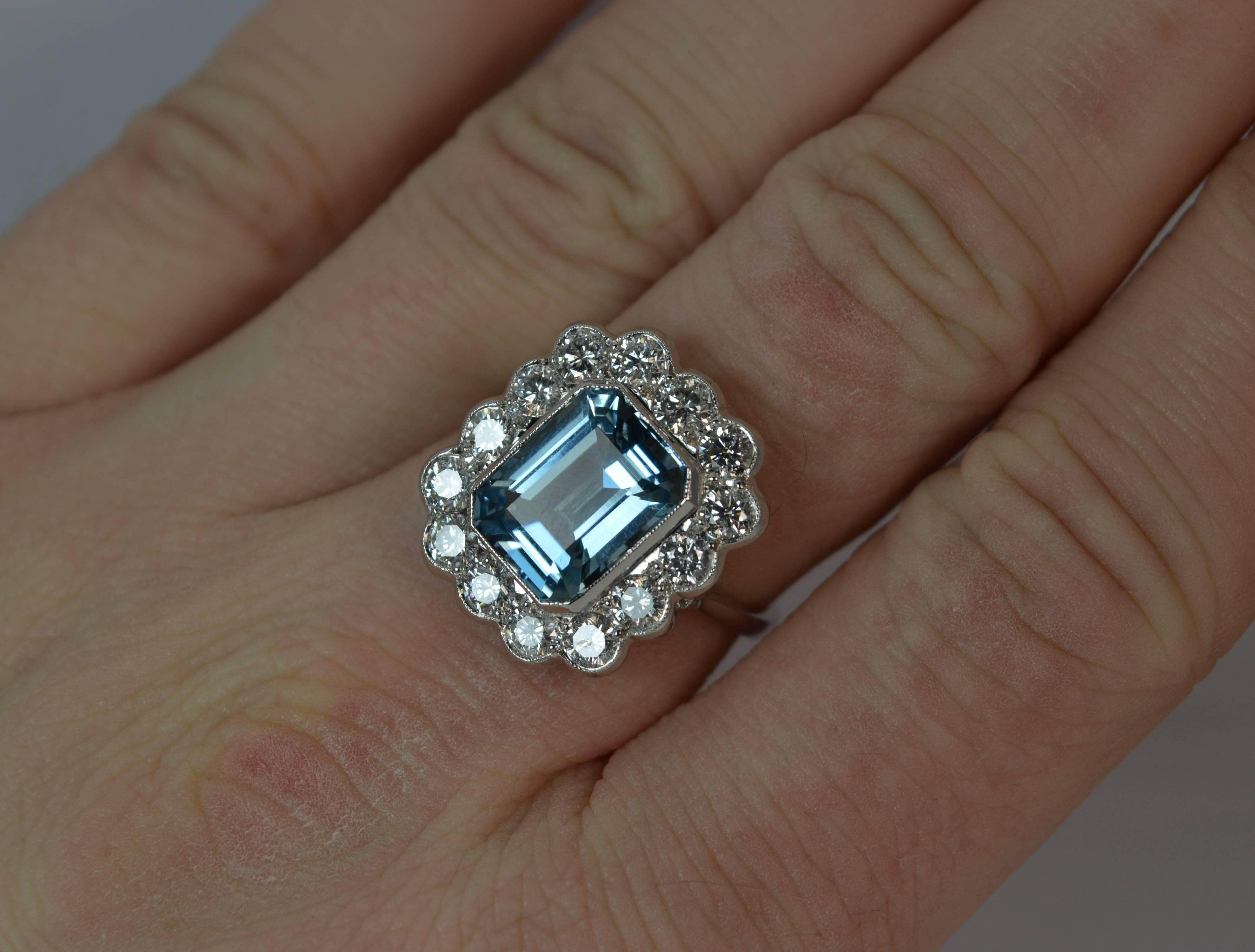 
A stunning Aquamarine and Diamond contemporary ring.

​Solid 18 carat white gold shank and setting.

​Designed with an emerald cut natural aquamarine to centre, 8.5mm x 11.1mm, 3.17 carats. Surrounding are 14 natural round brilliant cut diamonds to