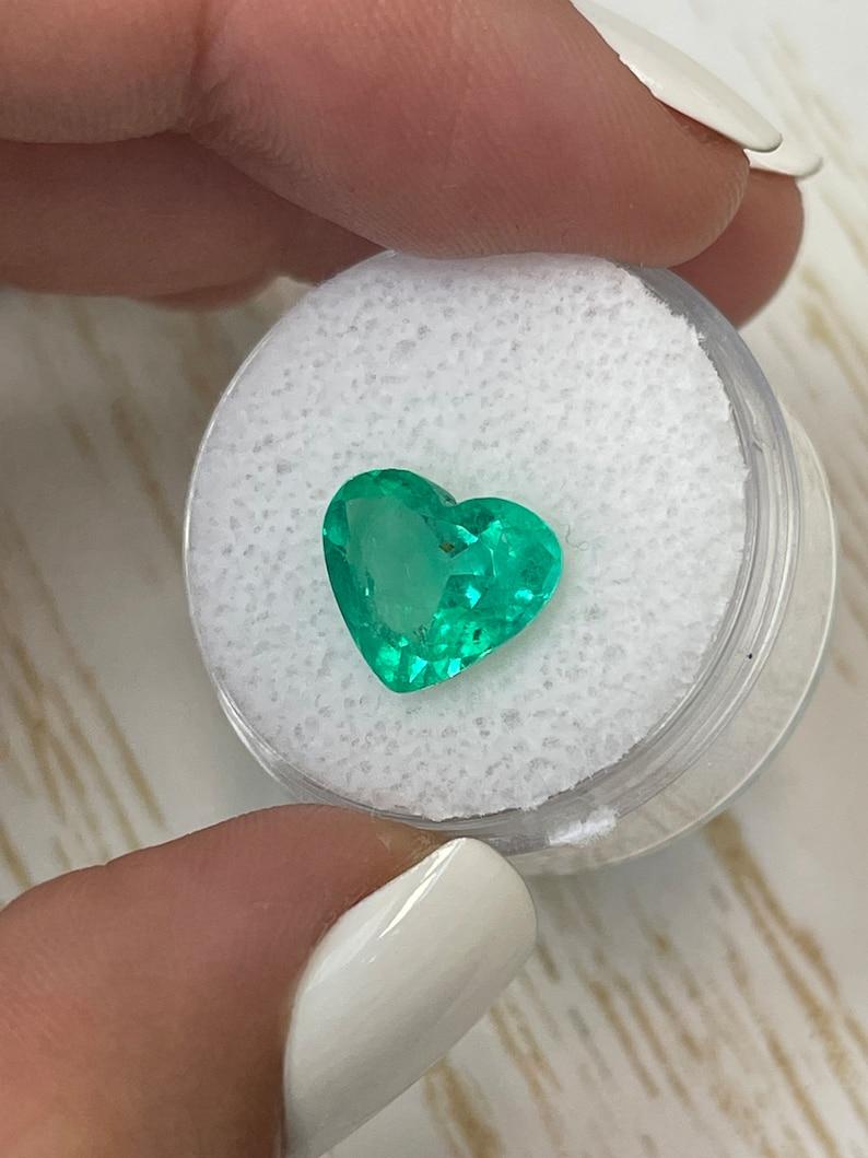 Stone: Emerald
Weight: 3.27-carats
Shape: Heart Cut
Clarity: Transparent
Luster: Excellent/Very Good
Color: Medium Bluish Green
Measurements: 9.71mm x 11.54mm x 5.76mm
Geographic Origin: Colombia
Treatment: Natural, Oiling

Comments: Due to their