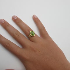 3.27 Carat Oval Peridot and .10 Carat Diamonds 18 Karat Yellow Gold Ring