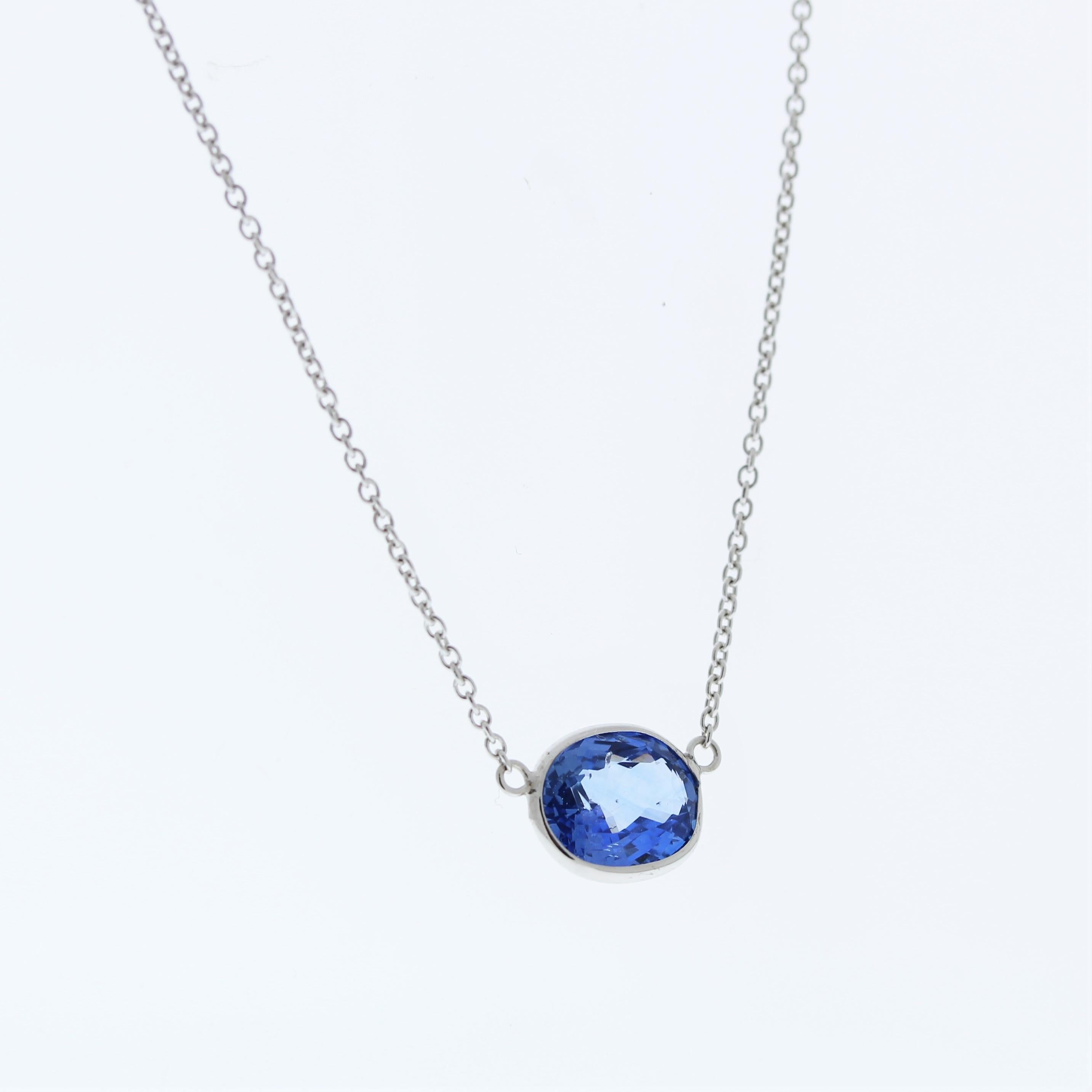 The necklace features a 3.27-carat oval-cut blue sapphire set in a 14 karat white gold pendant or setting. The use of white gold enhances the overall aesthetic, and the blue sapphire adds a touch of timeless elegance to the piece. This necklace