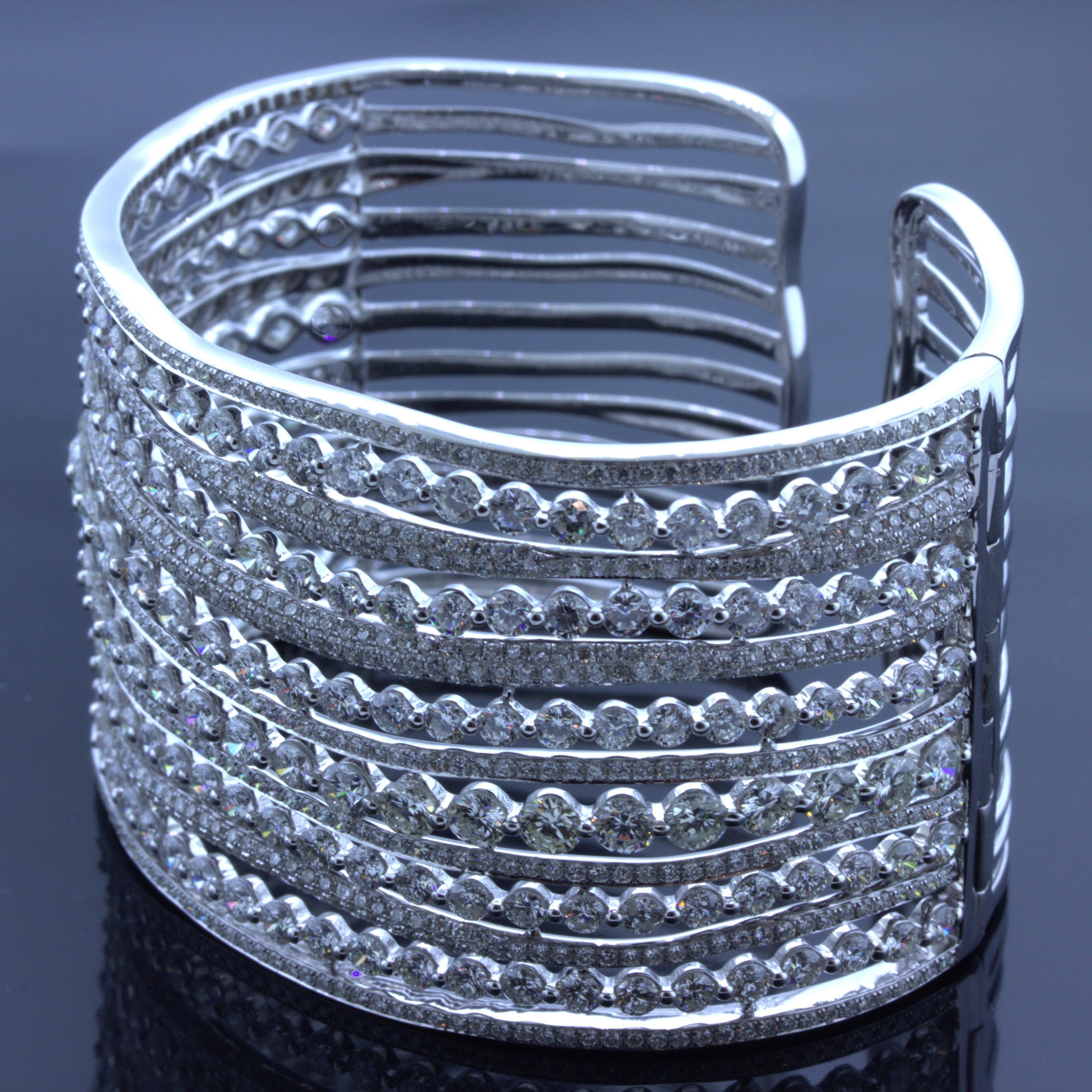 A sleek and sexy cuff bracelet featuring 32.76 carats of round brilliant-cut diamonds set in rows of waves. The cuff features interchanging rows of diamonds, switching from larger sized single diamonds to smaller pave-set diamonds giving the piece