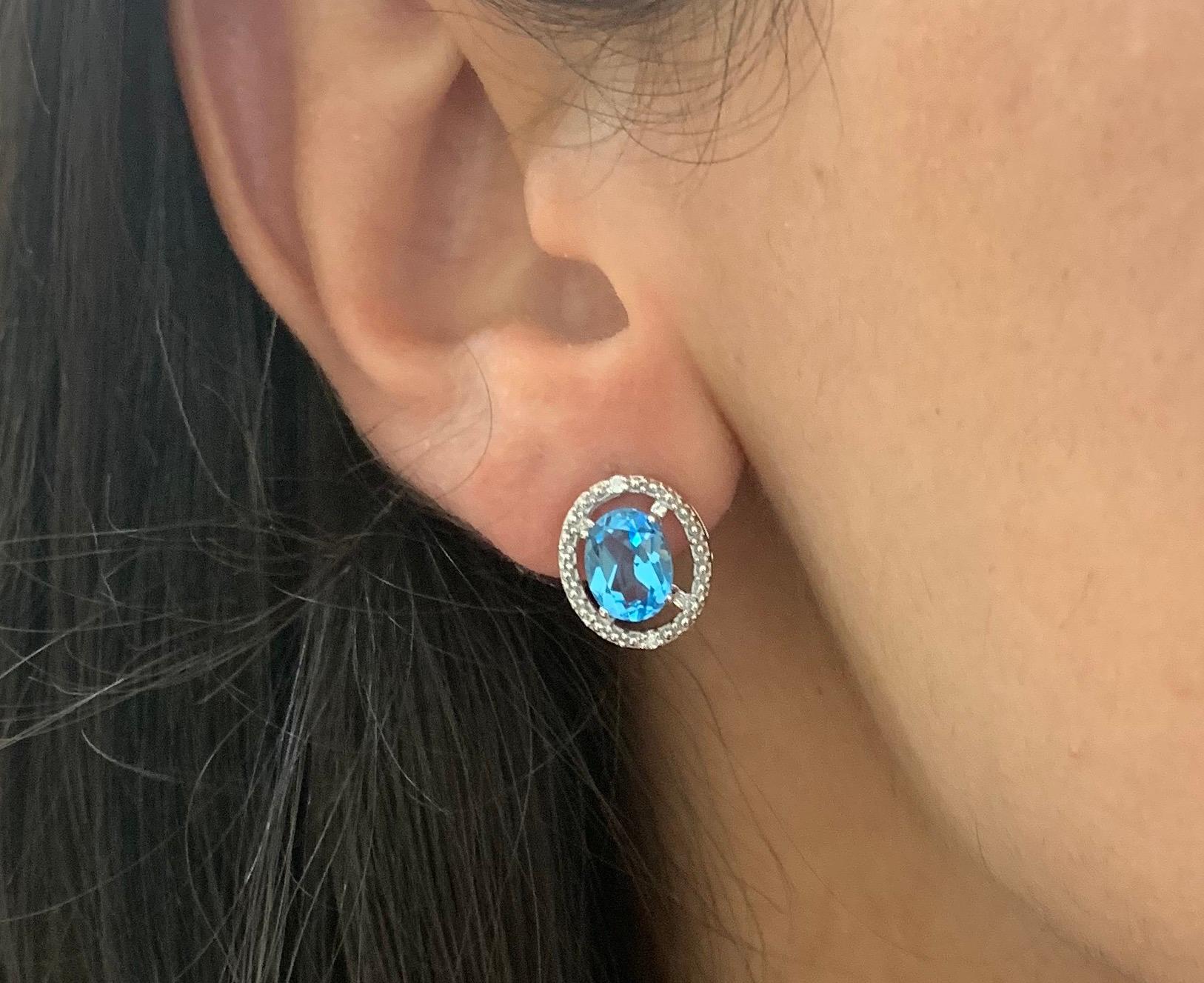 Material: 14k White Gold
Stone Details: 2 Oval Shaped Blue Topaz at 3.28 Carats Total- Measuring 8 x 6 mm
Diamond Details: 4 Brilliant Round White Diamonds at 0.02 Carats - Clarity: SI / Color H-I

Fine one-of-a-kind craftsmanship meets incredible