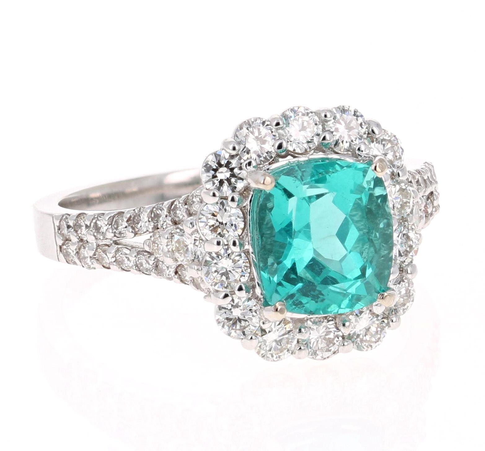 Gorgeous  Apatite and Diamond Ring.  
This ring has a 2.27 carat Cushion Cut Apatite in the center of the ring and is surrounded by 50 Round Cut Diamonds that weigh 1.01 carats (Clarity: VS2, Color:H).  The total carat weight of the ring is 3.28