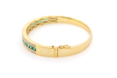 Armreif mit 3,28 Karat Smaragd und Diamant in Kanalfassung aus 18 Karat Gelbgold