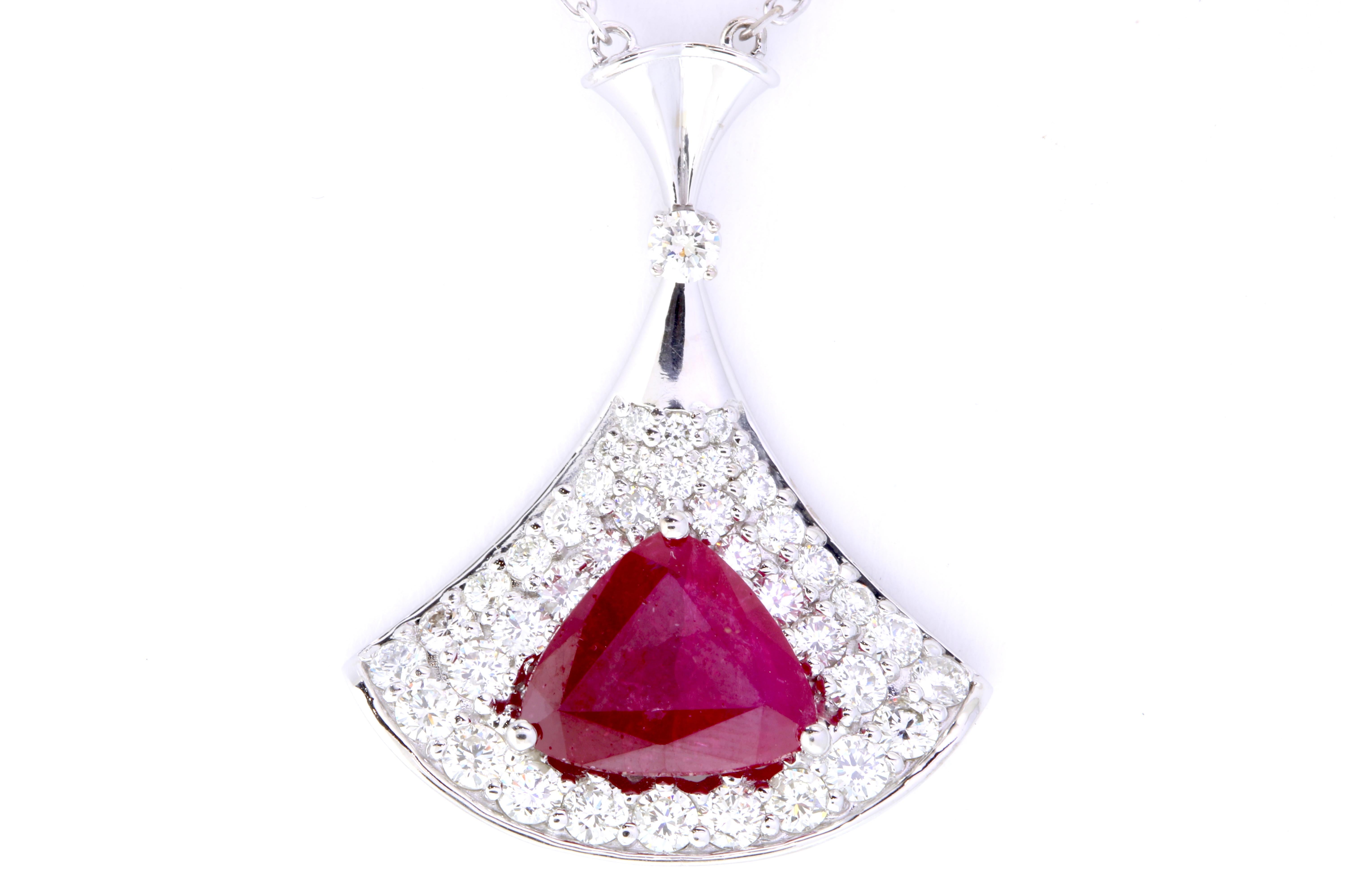 A beautiful and unique piece, this Trillion shaped Ruby lights up any look. Encased with 1.20 Carats of brilliant white diamonds, this necklace will delight jewelry lovers everywhere! 

Material: 14k White Gold 
Main Stone Details: 1 Trillion Cut