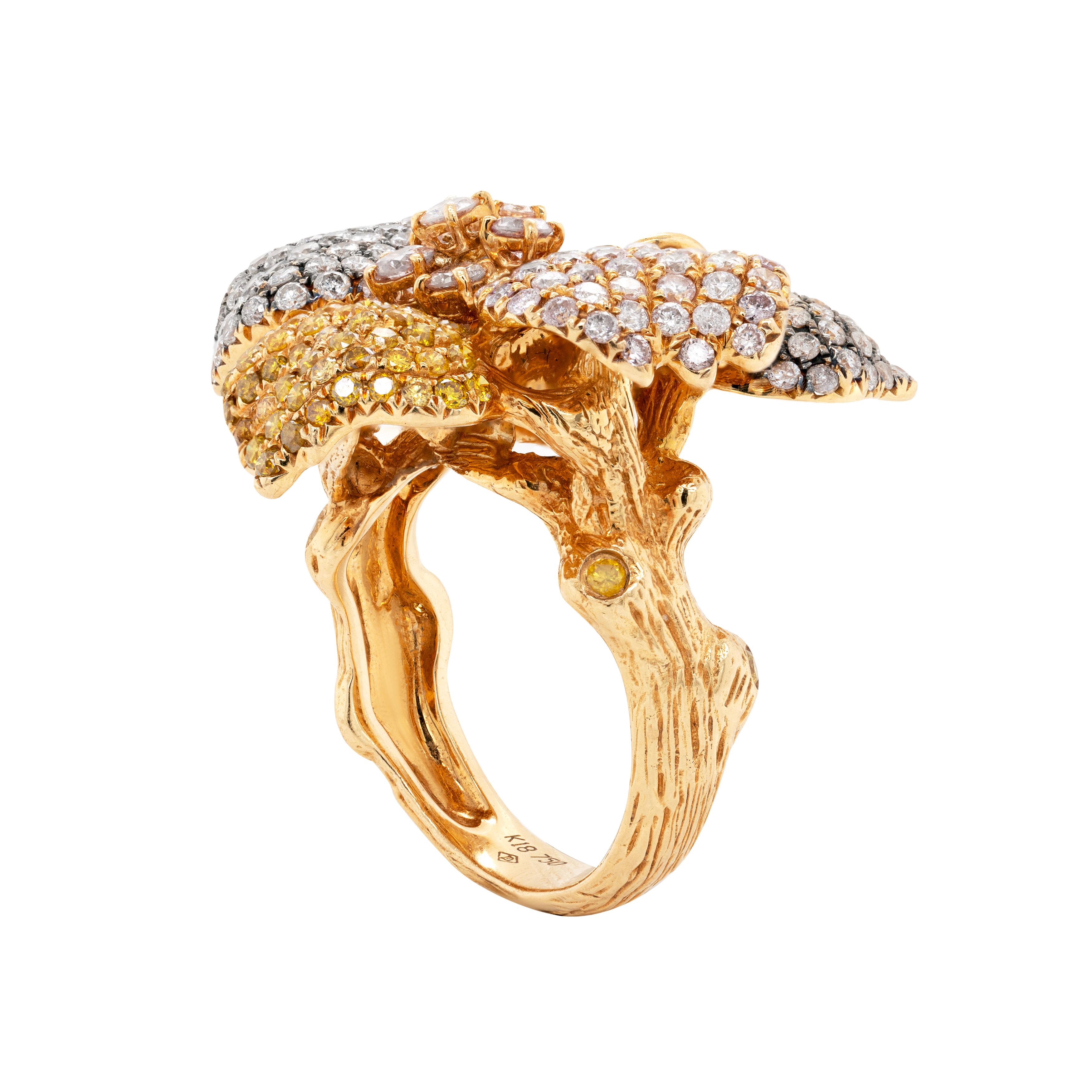 This spectacular cocktail ring showcases an intricate bloom orchid motif primarily crafted from 18 carat rose gold with white gold accents on two petals. The use of two-tone gold adds depth and dimension to the special ring whose petals are