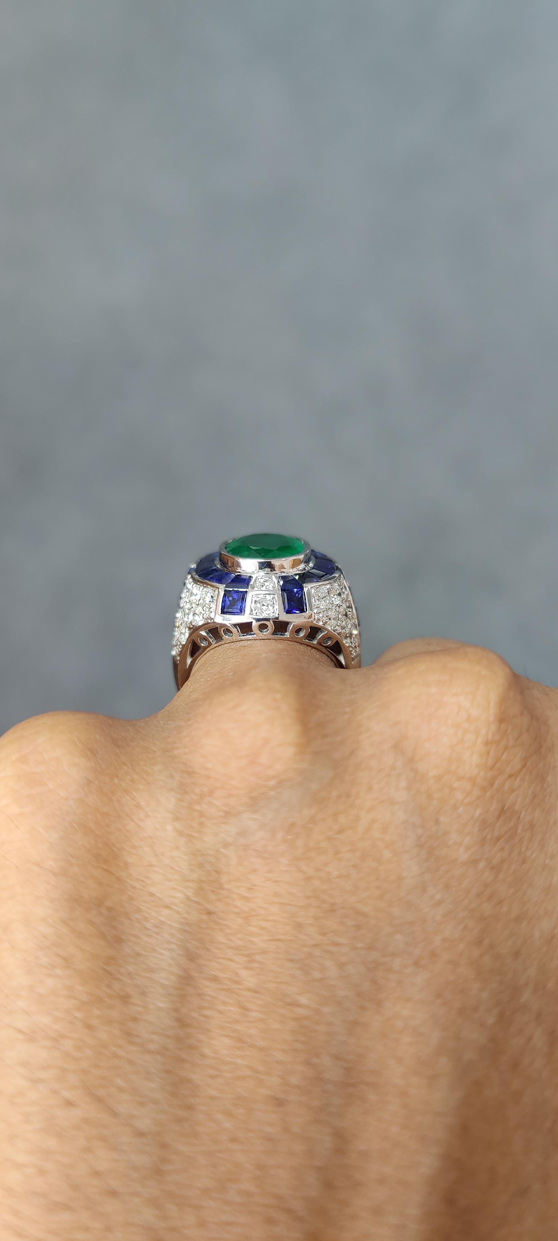 Women's or Men's 3.29 Carat Art Deco Emerald Ring studded with Blue Sapphires & Diamonds For Sale